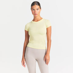 NikeSKIMS PERFORMANCE COTTON BLEND SHORT SLEEVE TOP | BICYCLE YELLOW ON A MODEL SIDE VIEW @ | FOCUS: 0.0, 1.0, 0.9