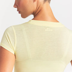 NikeSKIMS PERFORMANCE COTTON BLEND SHORT SLEEVE TOP | BICYCLE YELLOW ON A MODEL SIDE VIEW @ | FOCUS: 0.0, 1.0, 0.9