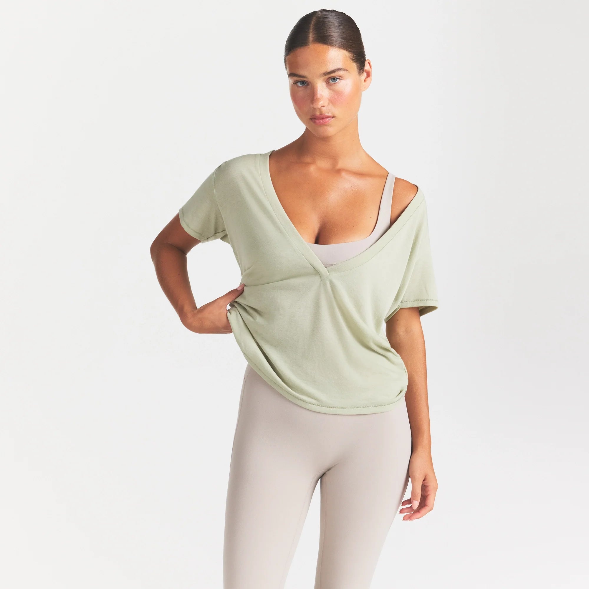 NikeSKIMS PERFORMANCE COTTON BLEND SHORT SLEEVE V-NECK TOP | TALC ON A MODEL SIDE VIEW @ | FOCUS: 0.0, 1.0, 0.9