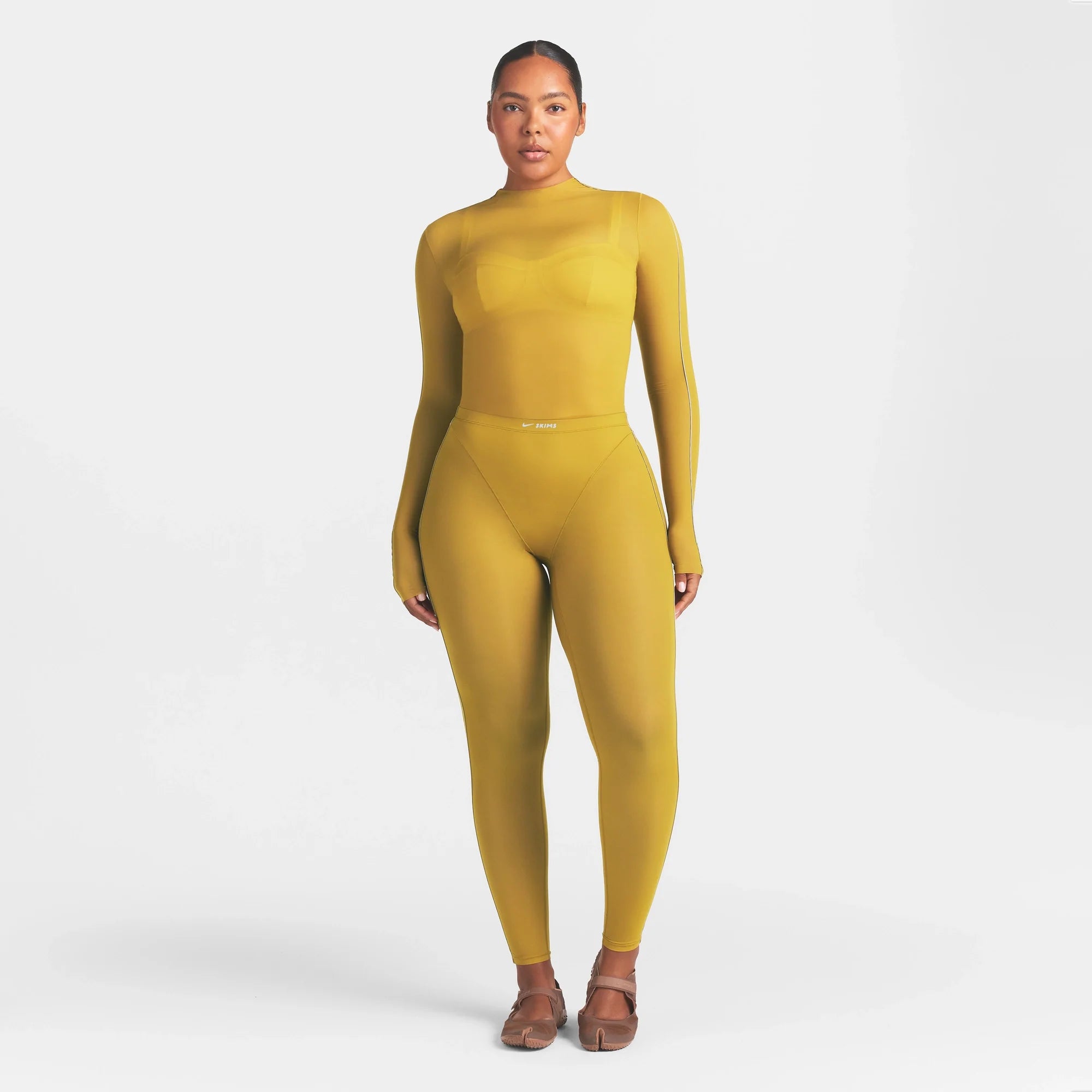 NikeSKIMS WEIGHTLESS LAYERS MOCK NECK LONG SLEEVE TOP | CITRINE ON A MODEL FRONT VIEW @ | FOCUS: 0.0, 1.0, 0.9
