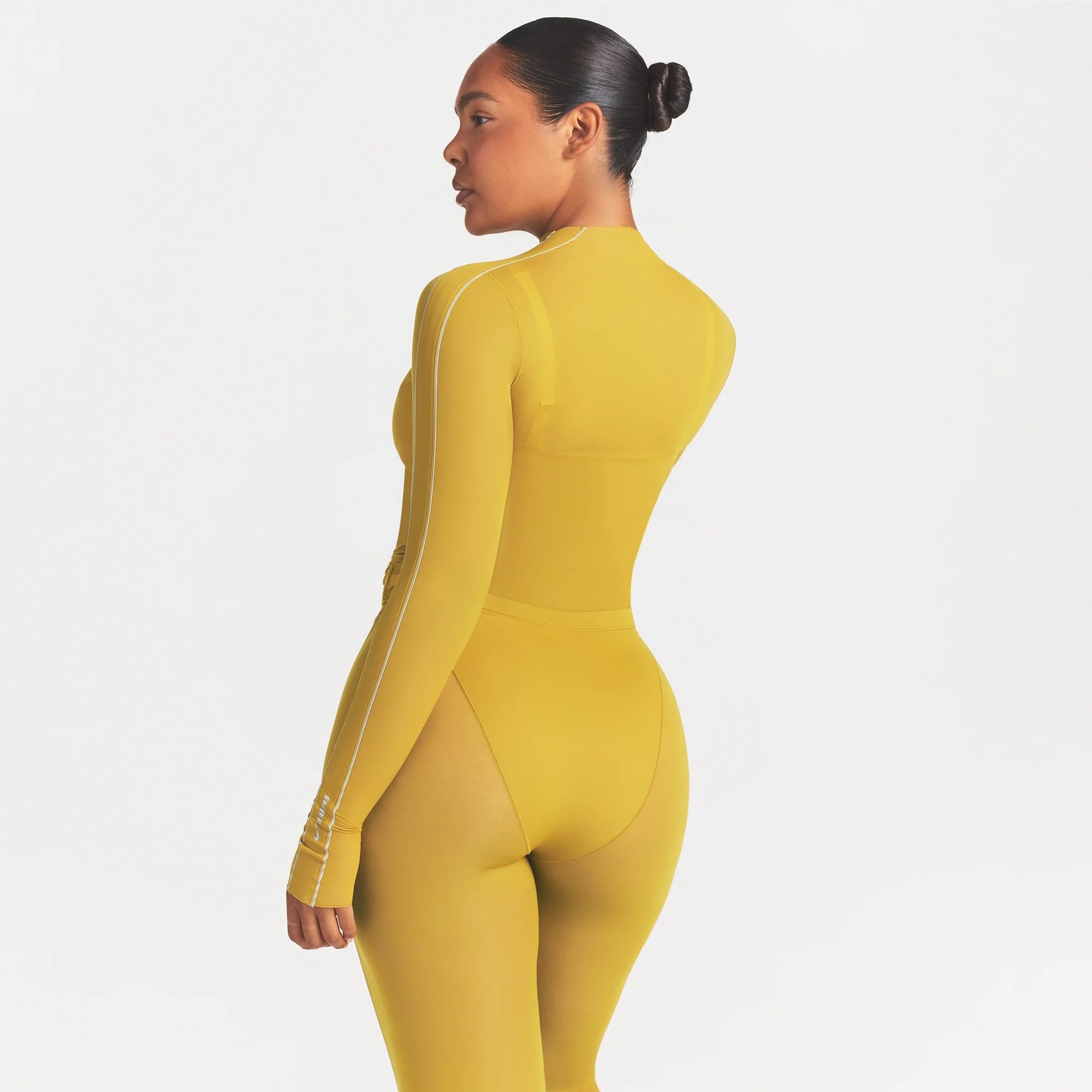 NikeSKIMS WEIGHTLESS LAYERS MOCK NECK LONG SLEEVE TOP | CITRINE ON A MODEL SIDE VIEW @ | FOCUS: 0.0, 1.0, 0.9