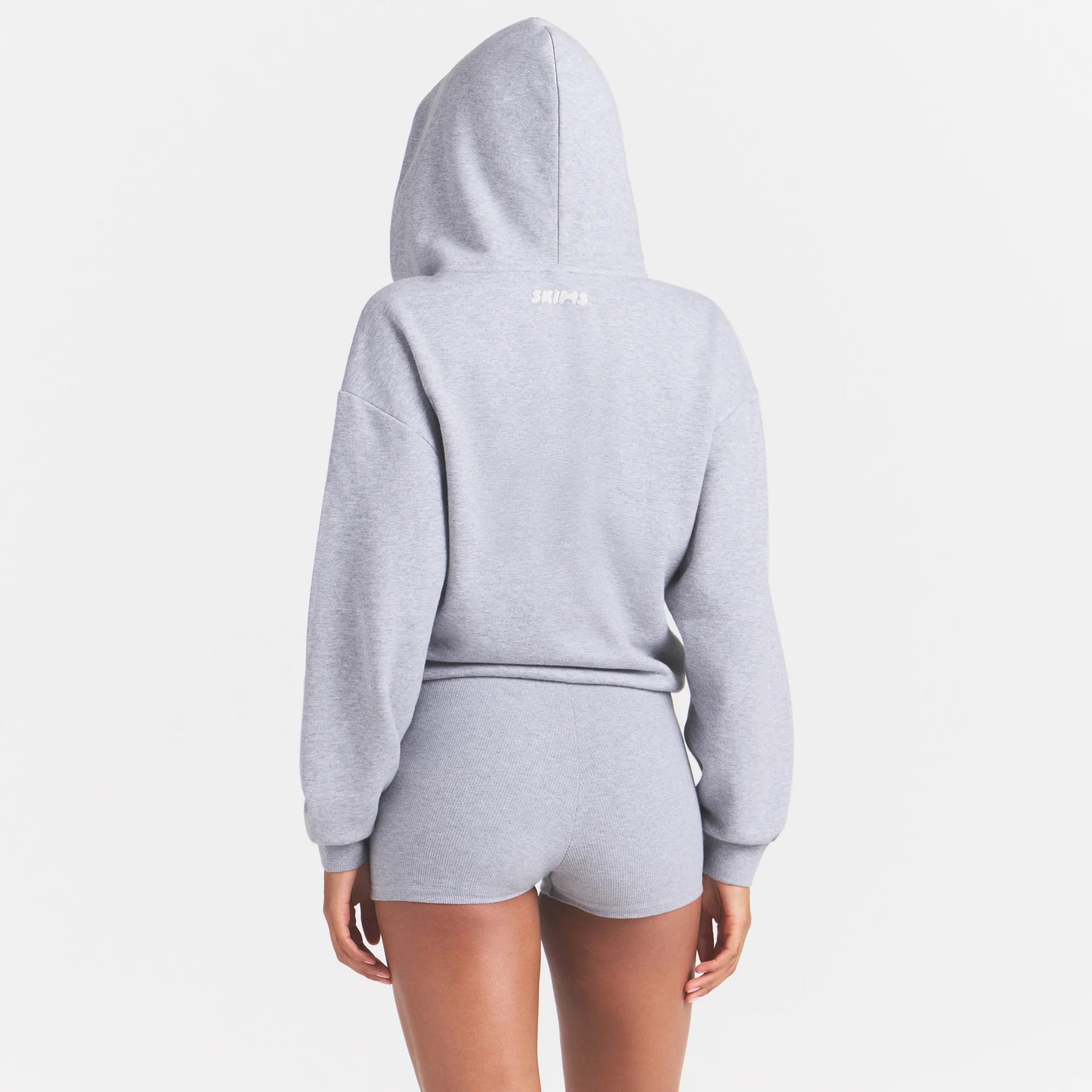 COTTON FLEECE ZIP UP ONESIE | HEATHER GREY ON A MODEL SIDE VIEW @ | FOCUS: 0.0, 1.0, 0.9