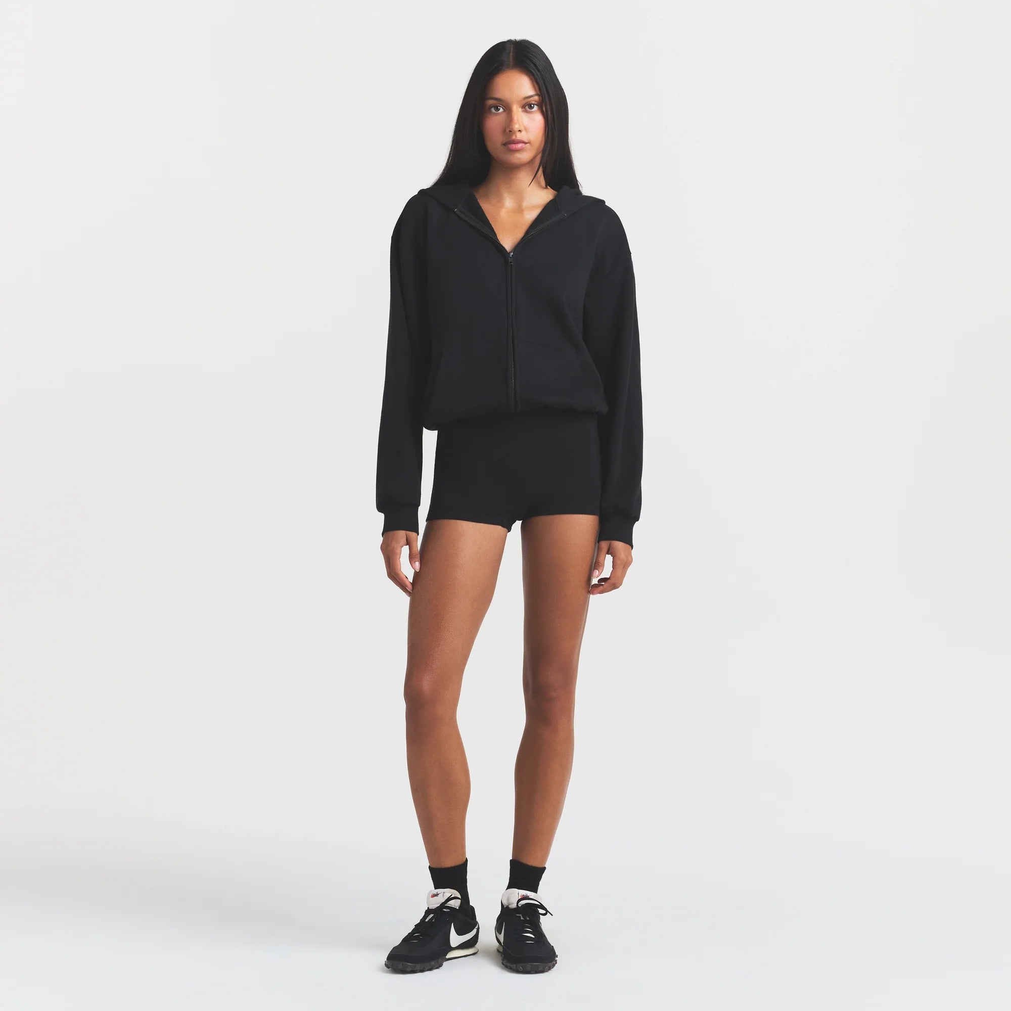 COTTON FLEECE ZIP UP ONESIE | ONYX ON A MODEL FRONT VIEW @ | FOCUS: 0.0, 1.0, 0.9