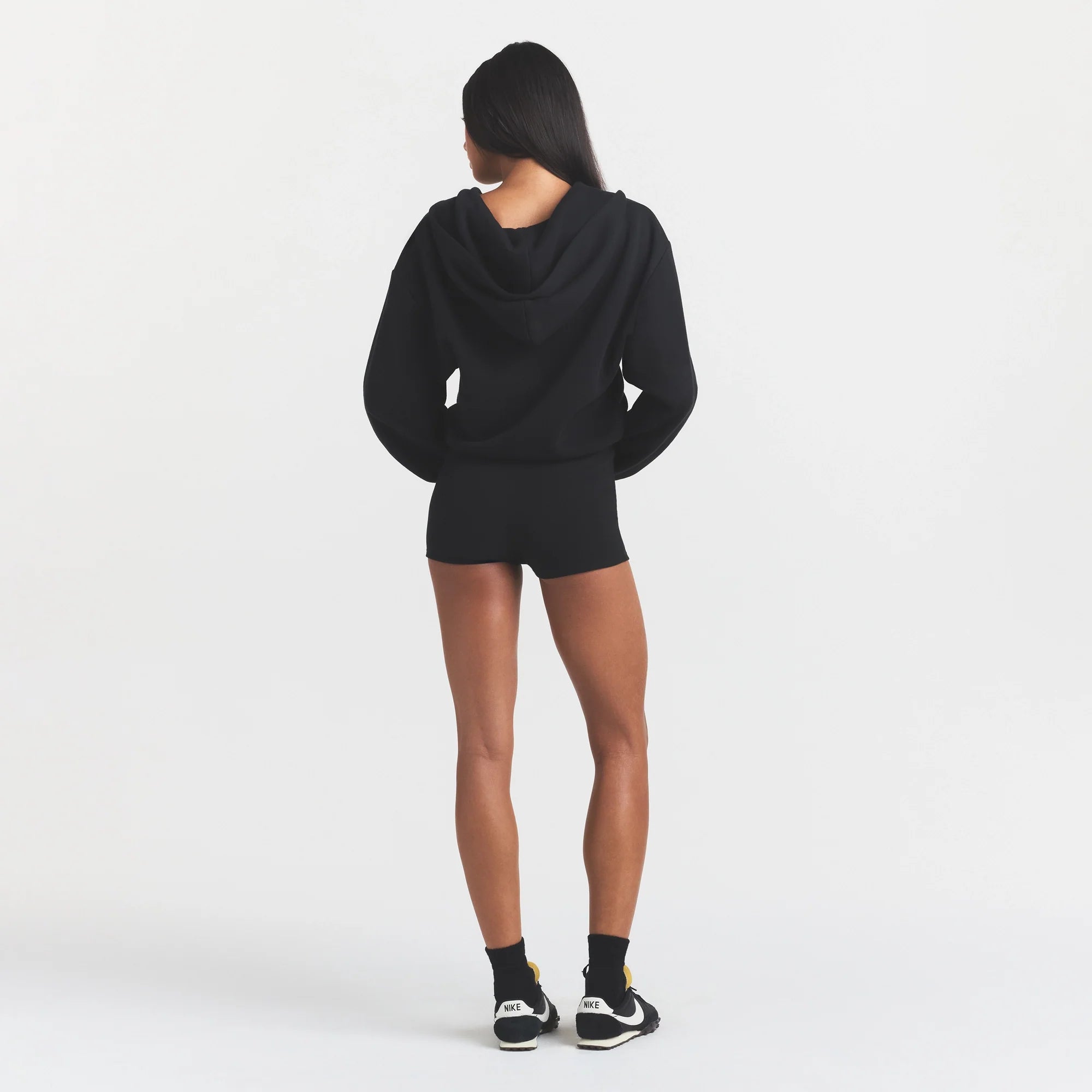 COTTON FLEECE ZIP UP ONESIE | ONYX ON A MODEL FRONT VIEW @ | FOCUS: 0.0, 1.0, 0.9