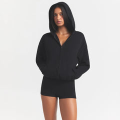 COTTON FLEECE ZIP UP ONESIE | ONYX ON A MODEL SIDE VIEW @ | FOCUS: 0.0, 1.0, 0.9