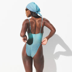 SIGNATURE SWIM PLUNGE ONE PIECE | CYAN FK OMBRE PRINT ON A MODEL SIDE VIEW 