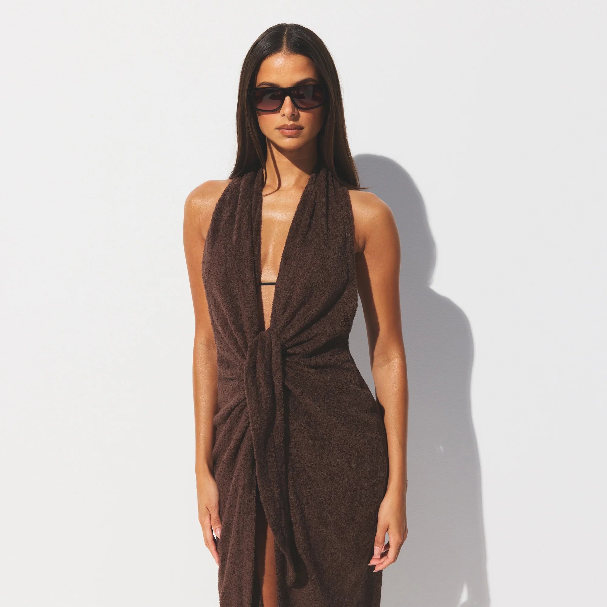 TERRY COVER-UPS DEEP PLUNGE HALTER WRAP DRESS | DARK SEPIA ON A MODEL SIDE VIEW @ | FOCUS: 0.0, 1.0, 0.9 