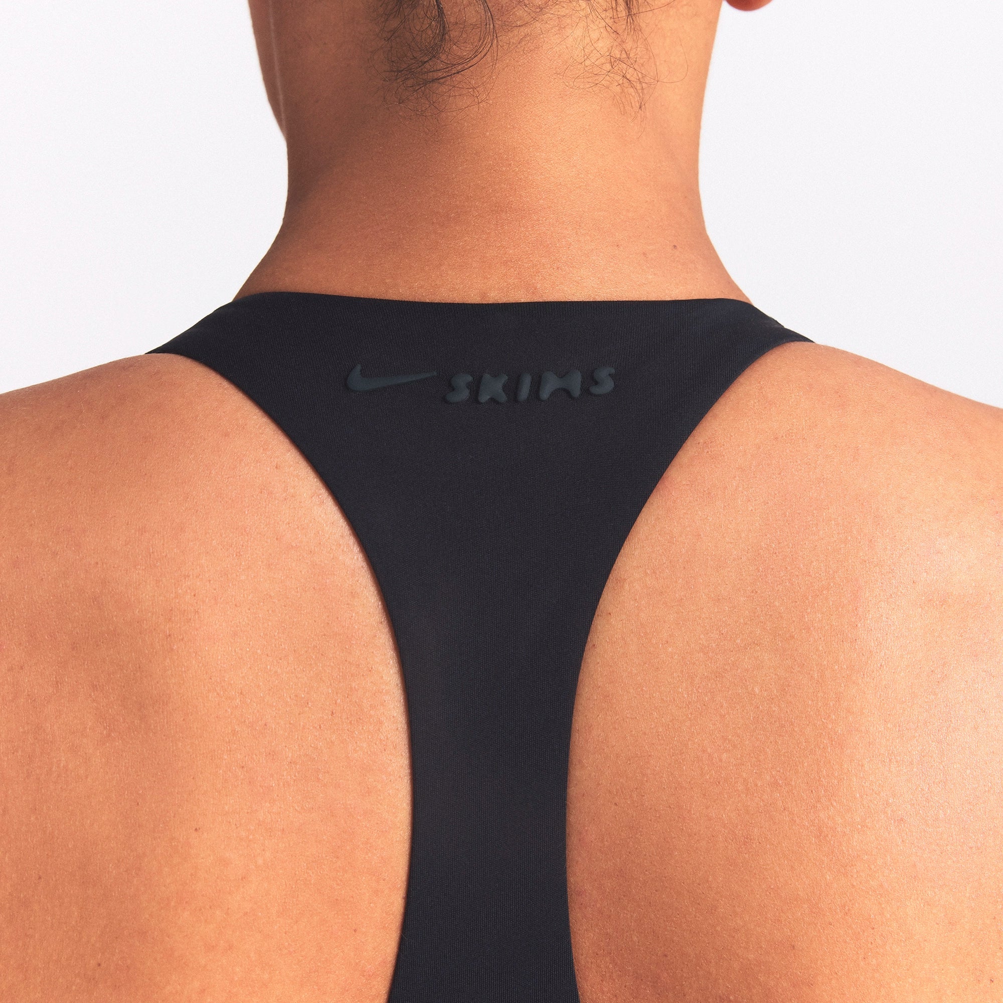 NikeSKIMS MATTE AND SHINE RACERBACK 5" ONE PIECE | OBSIDIAN/IGNEOUS ON A MODEL SIDE VIEW @ | FOCUS: 0.0, 1.0, 0.9