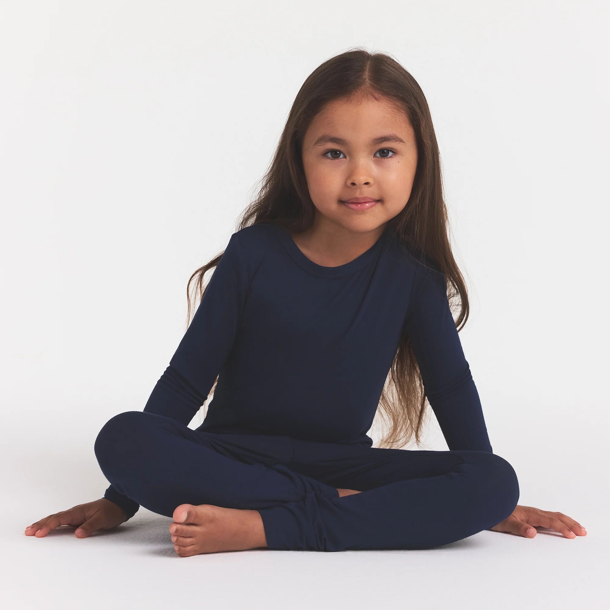 SKIMS SLEEP KIDS SLEEP SET | NAVY ON A MODEL FRONT VIEW @ | FOCUS: 0.0, 1.0, 0.9