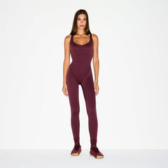 NikeSKIMS MATTE RACER LONG ONESIE | CURRANT ON A MODEL FRONT VIEW @ | FOCUS: 0.0, 1.0, 0.9