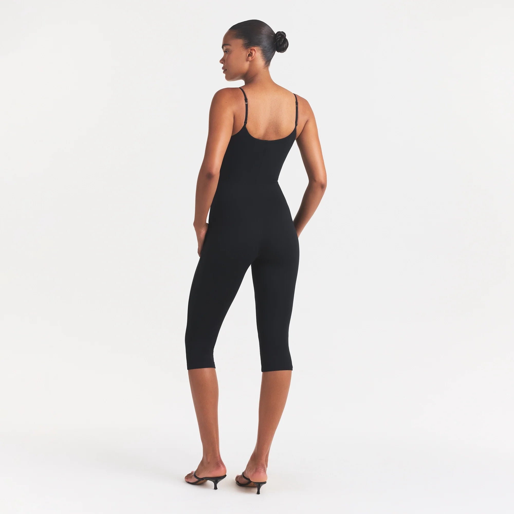 SMOOTH LAYERS CAPRI CATSUIT | OBSIDIAN ON A MODEL FRONT VIEW @ | FOCUS: 0.0, 1.0, 0.9