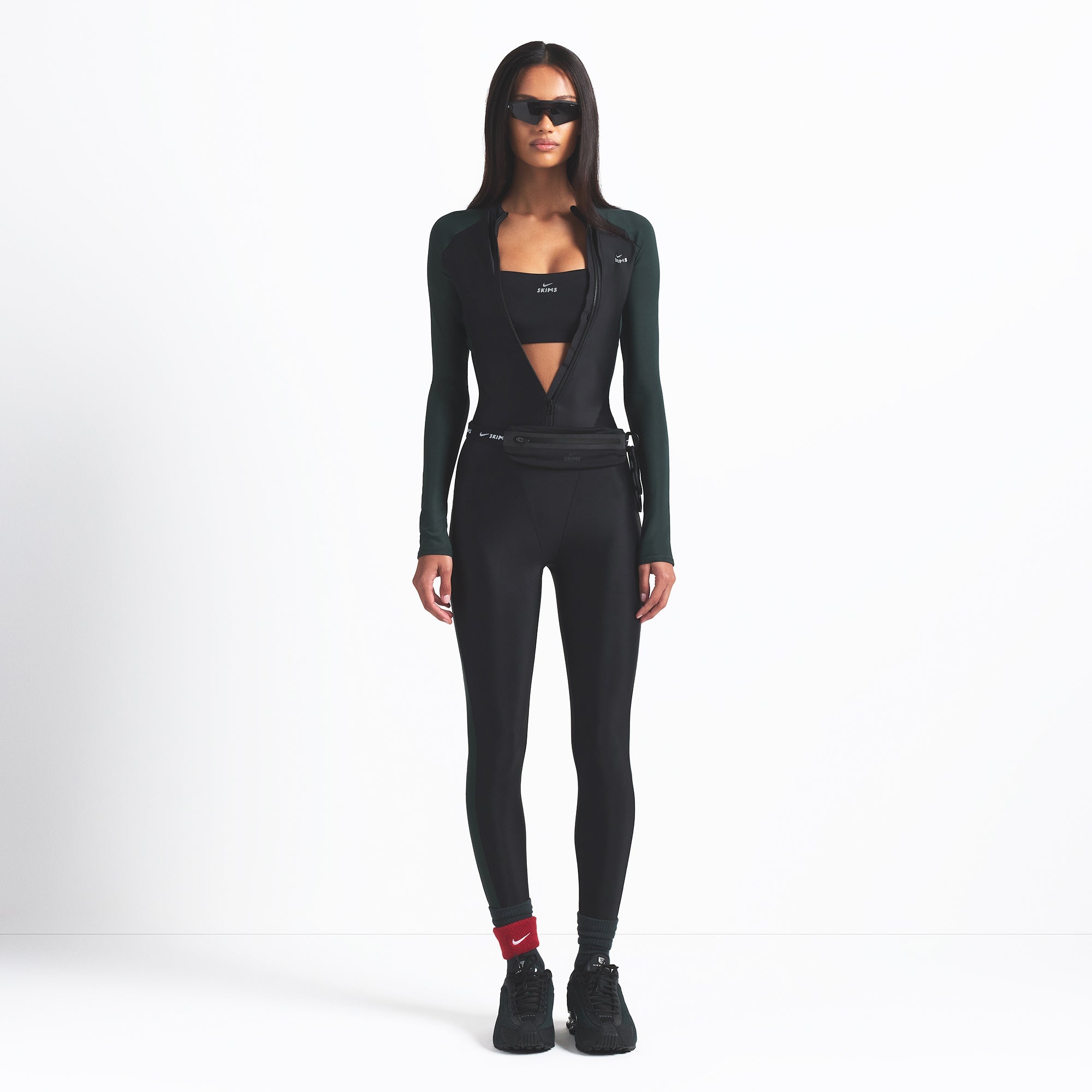 NikeSKIMS SHINE ZIP FRONT LONG ONESIE | OBSIDIAN AND DARK TEAL ON A MODEL FRONT VIEW @ | FOCUS: 0.0, 1.0, 0.9