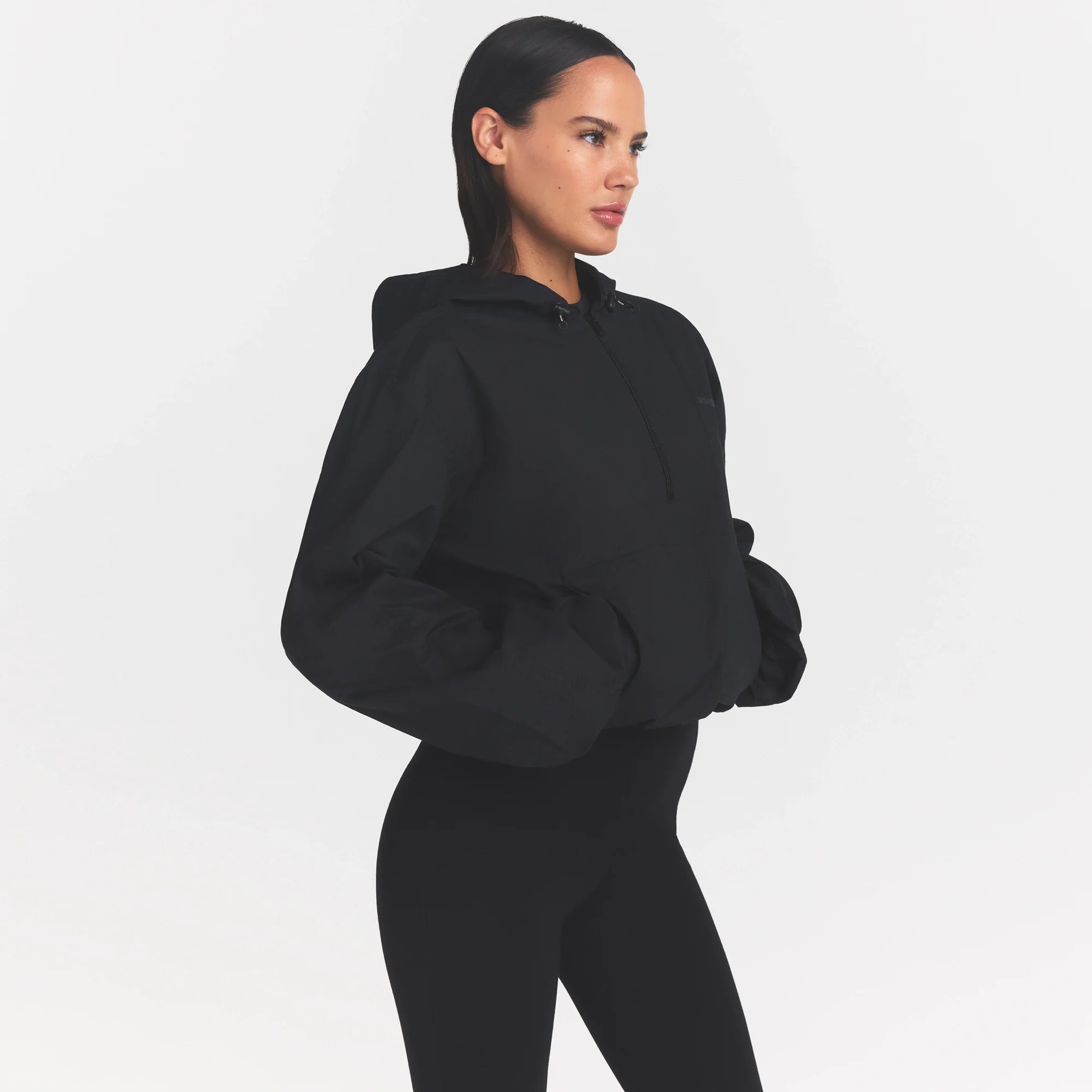 WOVEN COTTON HALF ZIP PULLOVER | ONYX ON A MODEL SIDE VIEW @ | FOCUS: 0.0, 1.0, 0.9
