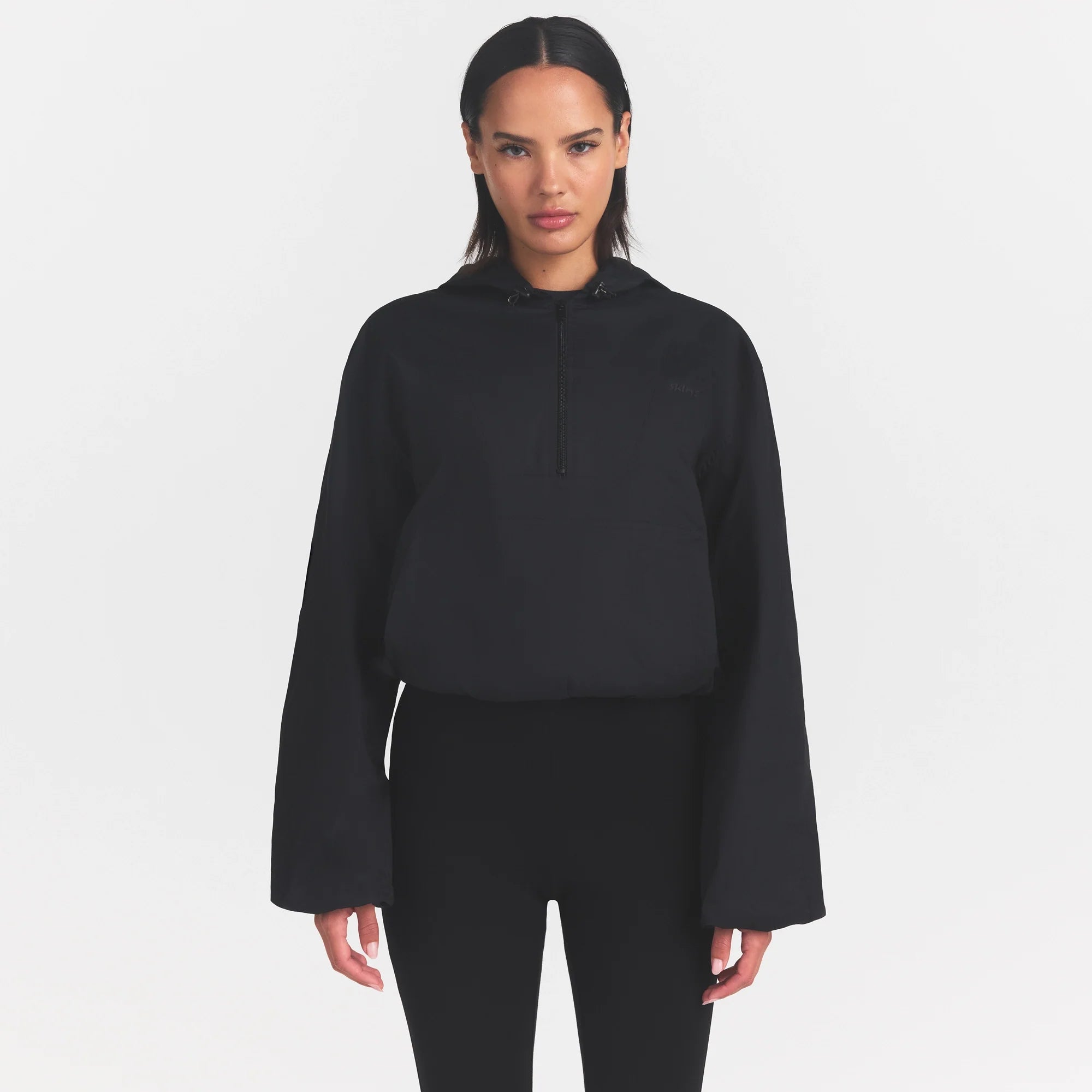 WOVEN COTTON HALF ZIP PULLOVER | ONYX ON A MODEL SIDE VIEW @ | FOCUS: 0.0, 1.0, 0.9
