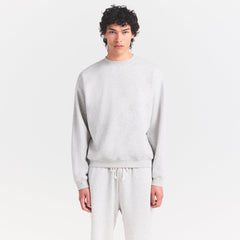 FLEECE LOUNGE MENS RELAXED HIGH CREWNECK | LIGHT HEATHER GREY ON A MODEL SIDE VIEW @ | FOCUS: 0.0, 1.0, 0.9