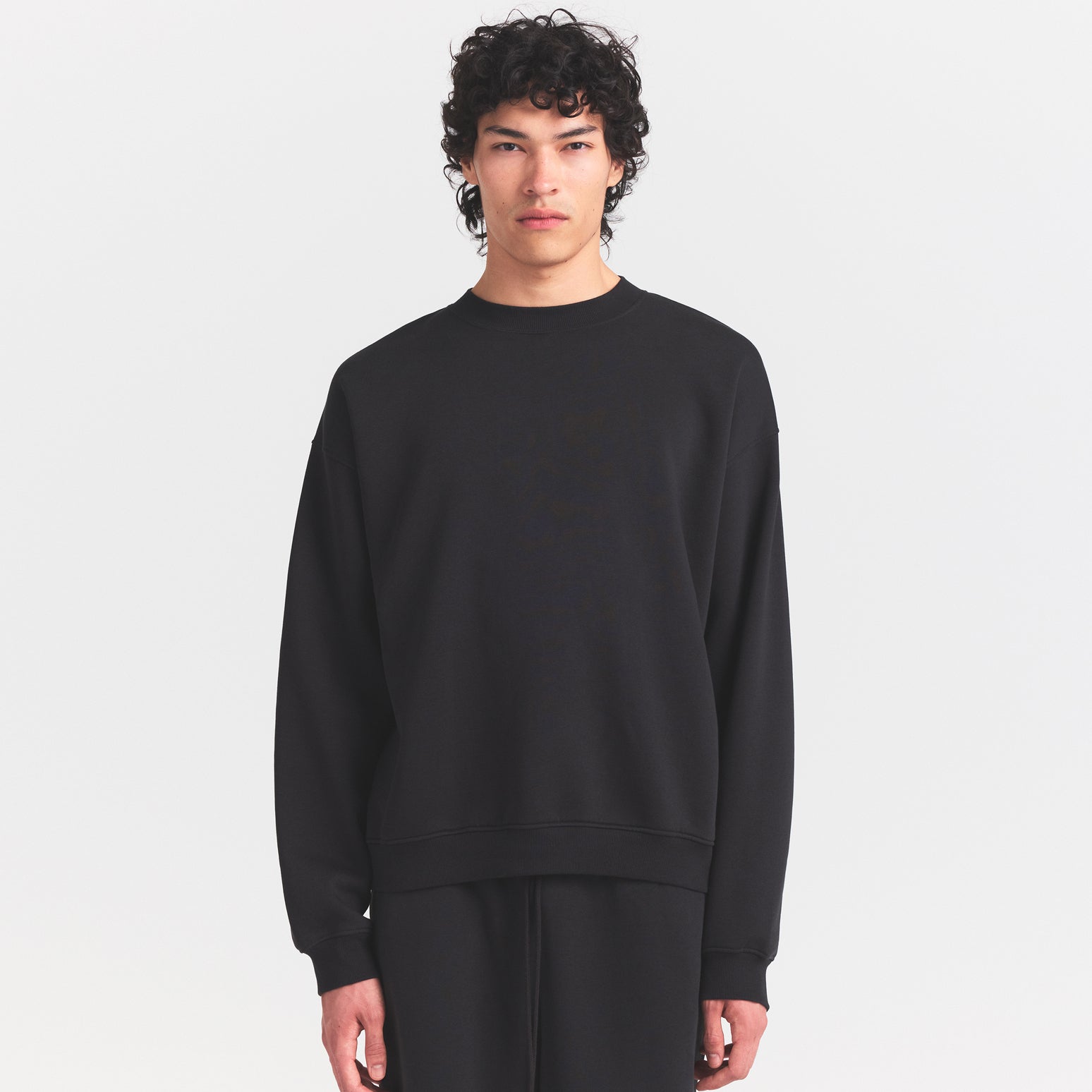 FLEECE LOUNGE MENS RELAXED HIGH CREWNECK | WASHED ONYX ON A MODEL SIDE VIEW @ | FOCUS: 0.0, 1.0, 0.9