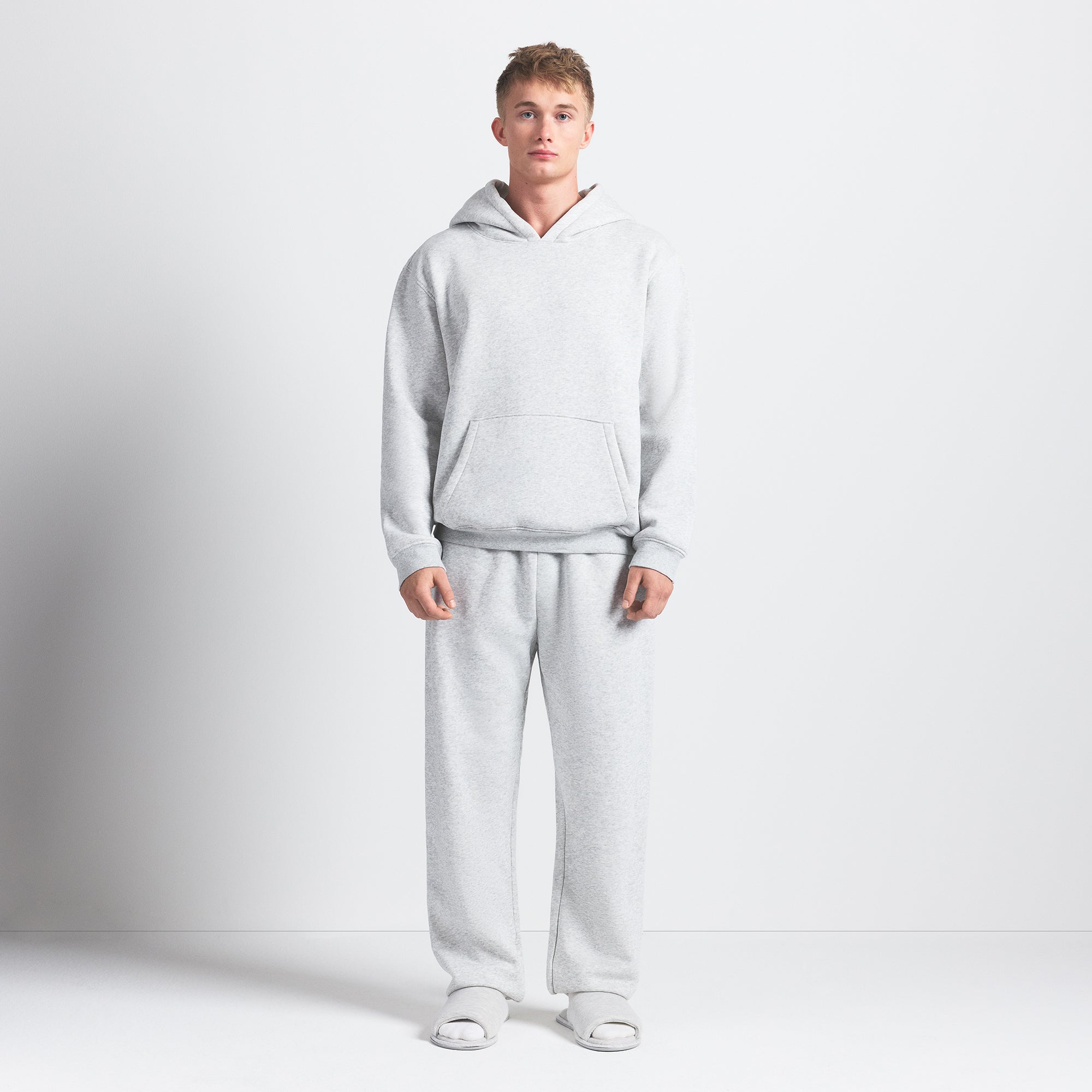 FLEECE LOUNGE MENS RELAXED HOODIE | LIGHT HEATHER GREY ON A MODEL FRONT VIEW @ | FOCUS: 0.0, 1.0, 0.9