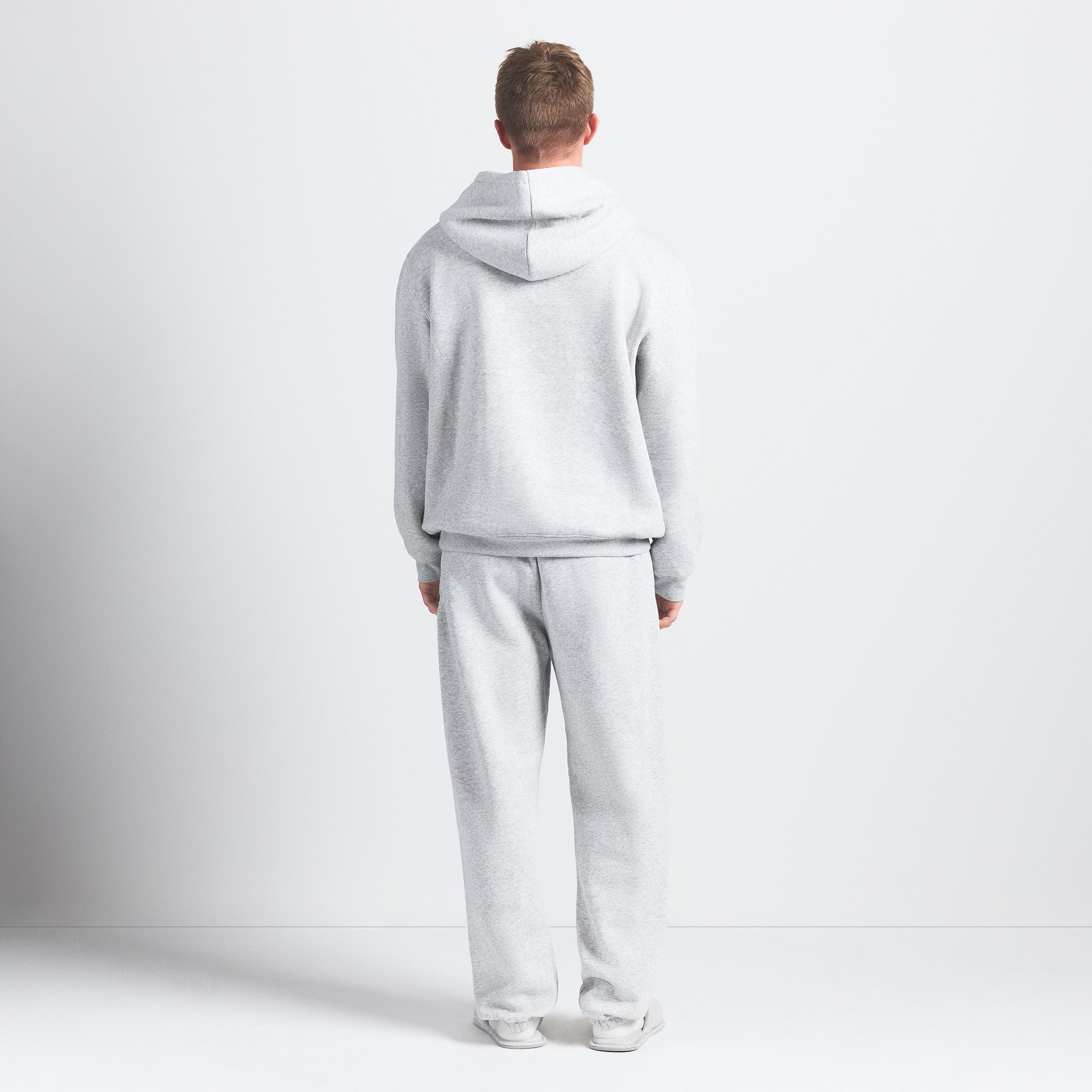 FLEECE LOUNGE MENS RELAXED HOODIE | LIGHT HEATHER GREY ON A MODEL BACK VIEW @ | FOCUS: 0.0, 1.0, 0.9