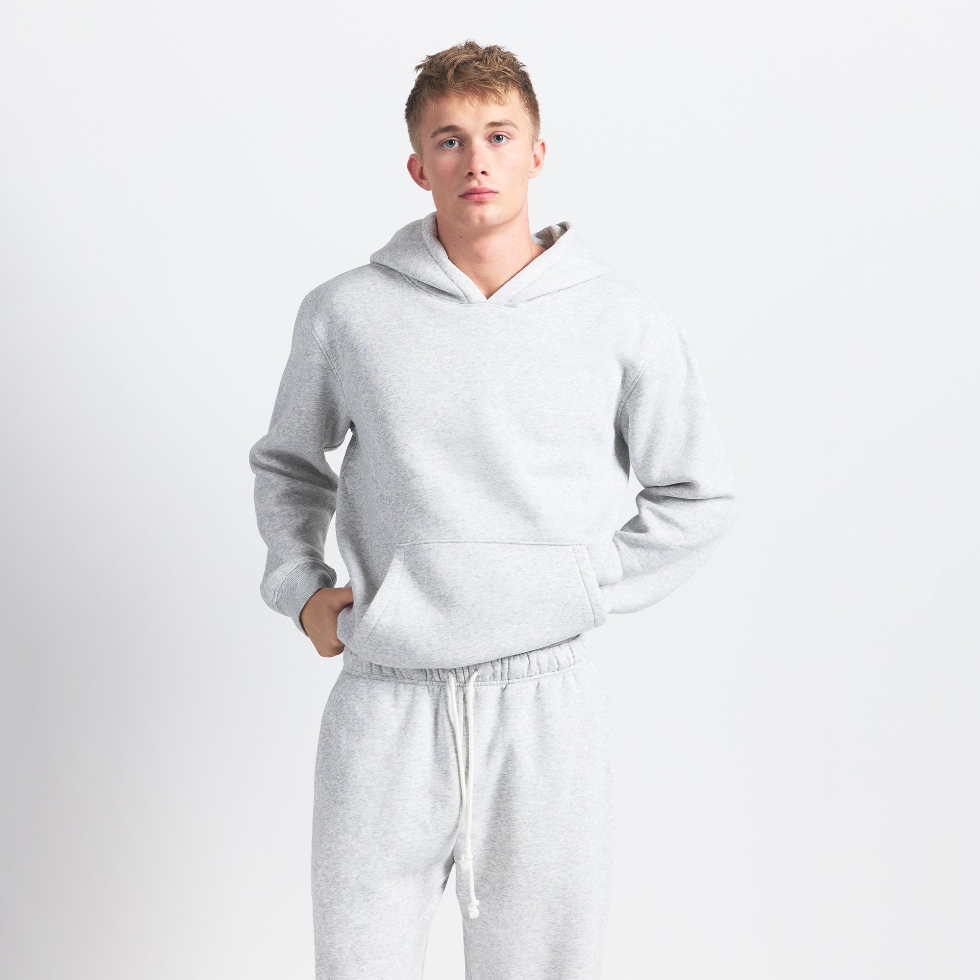 FLEECE LOUNGE MENS RELAXED HOODIE | LIGHT HEATHER GREY ON A MODEL FRONT VIEW @ | FOCUS: 0.0, 1.0, 0.9