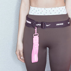 NikeSKIMS ACCESSORIES KEYCHAIN WRISTLET | LIGHT FLAMINGO CAMPAIGN @ | FOCUS: 0.0, 1.0, 0.9