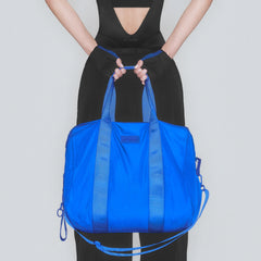NikeSKIMS ACCESSORIES PUFFER GYM BAG | COBALT & LAYS FLAT ON A WHITE BACKGROUND | FLT