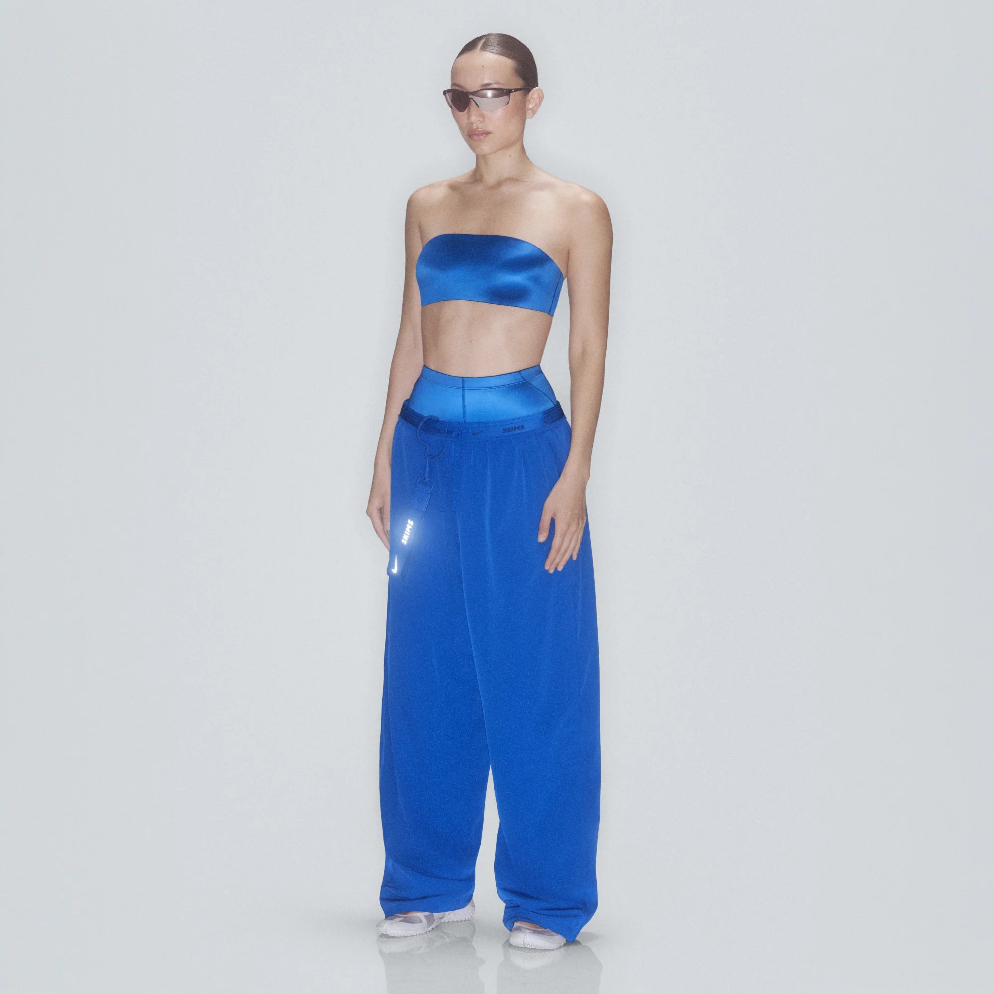 NikeSKIMS STRETCH NYLON OVERSIZED PANT | COBALT & LAYS FLAT ON A WHITE BACKGROUND | FLT