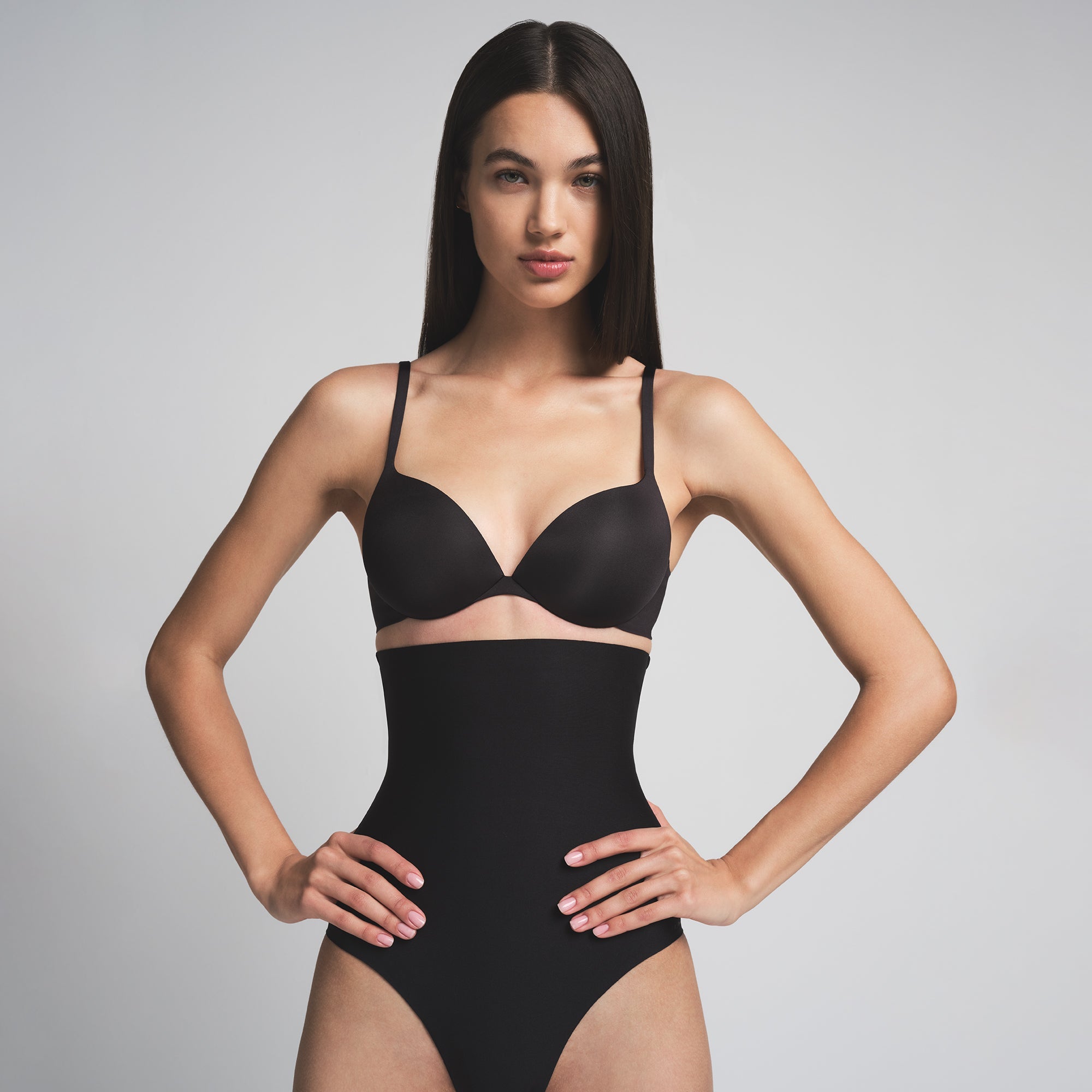 SKIMS BODY CORE SCULPT HIGH-WAISTED BRIEF | ONYX  ON A MODEL FRONT VIEW