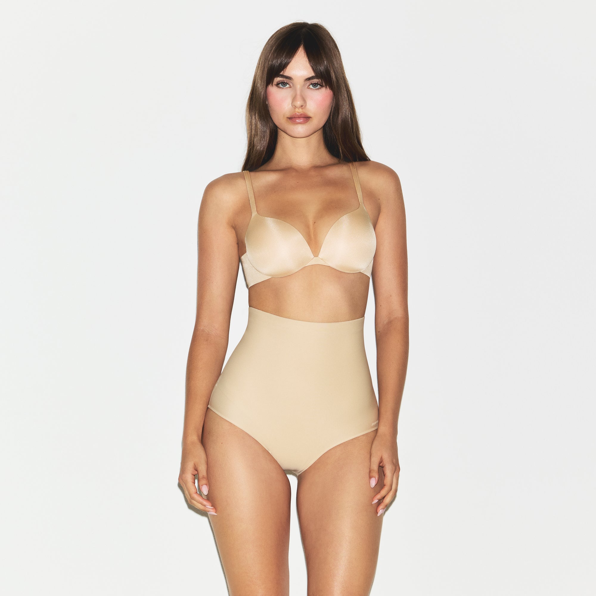 SKIMS BODY CORE SCULPT BUTT LIFTING BRIEF | SAND ON A MODEL SIDE VIEW @