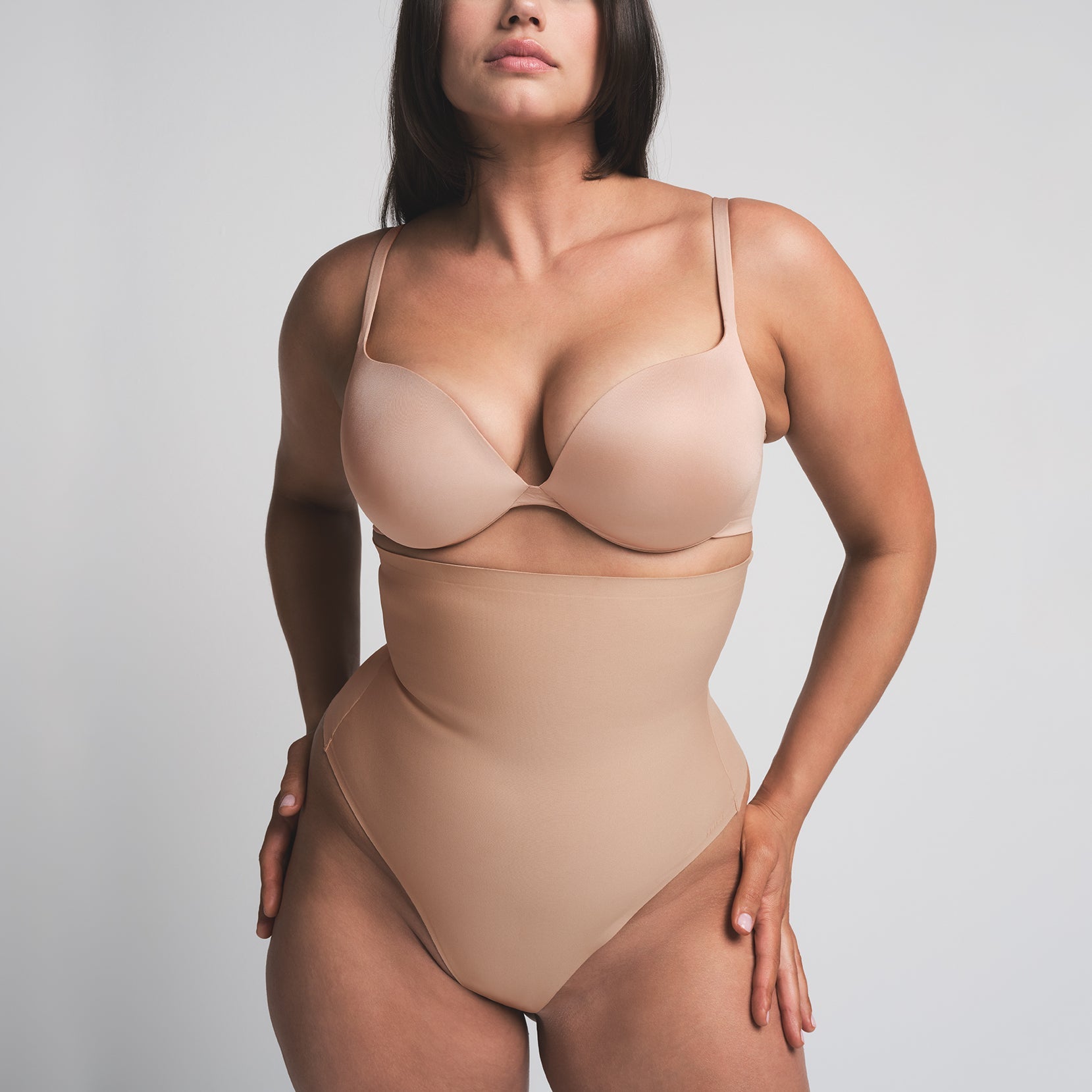 SKIMS BODY CORE SCULPT HIGH-WAISTED THONG | CLAY  ON A MODEL FRONT VIEW