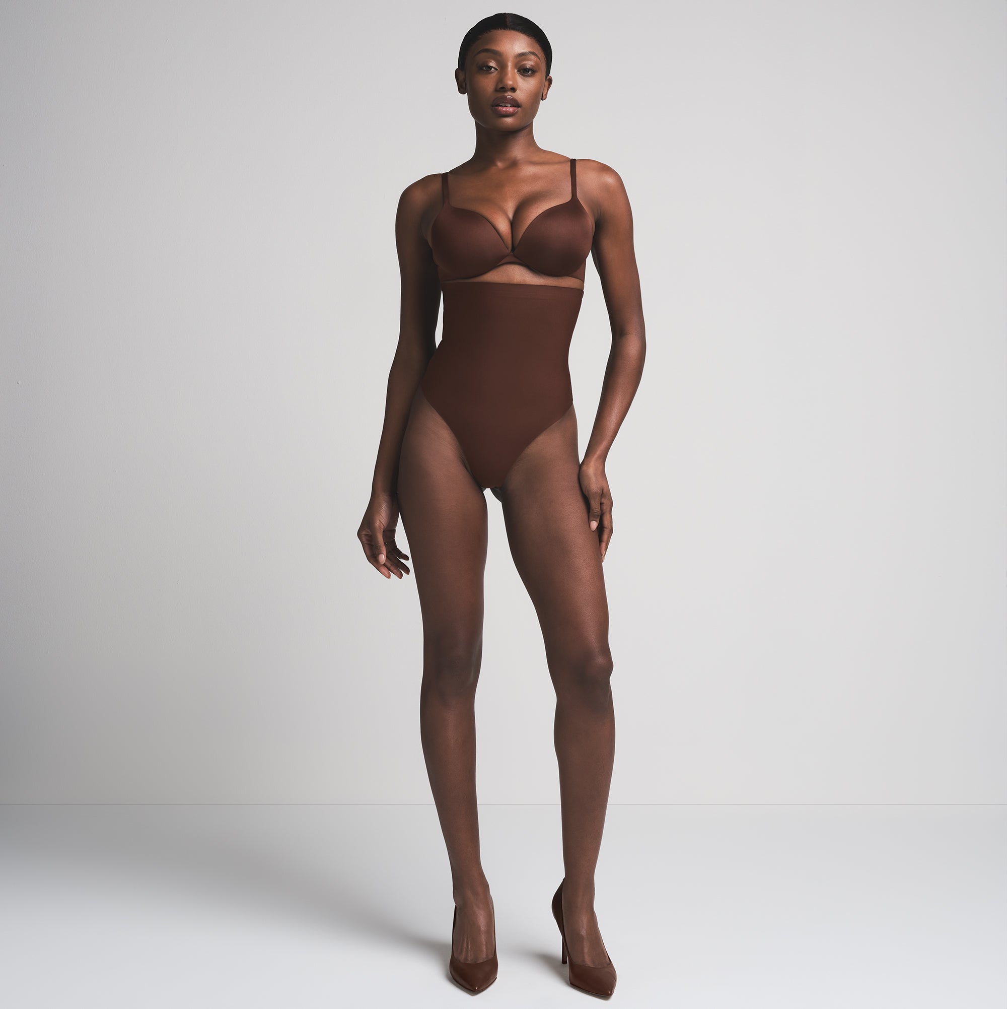 SKIMS BODY CORE SCULPT HIGH-WAISTED THONG | COCOA  ON A MODEL FRONT VIEW