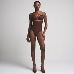 SKIMS BODY CORE SCULPT HIGH-WAISTED THONG | COCOA  ON A MODEL FRONT VIEW