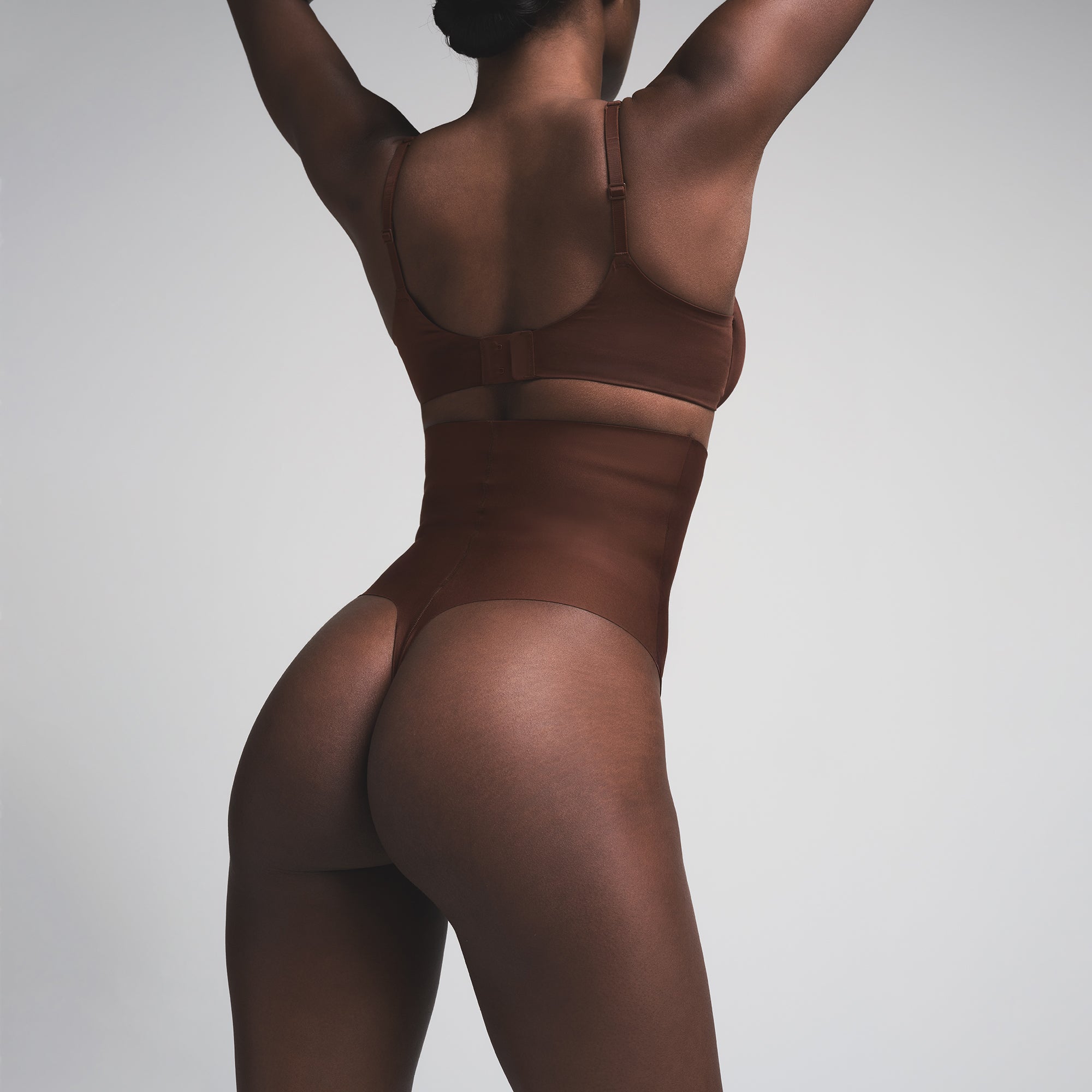 SKIMS BODY CORE SCULPT HIGH-WAISTED THONG | COCOA  ON A MODEL BACK VIEW