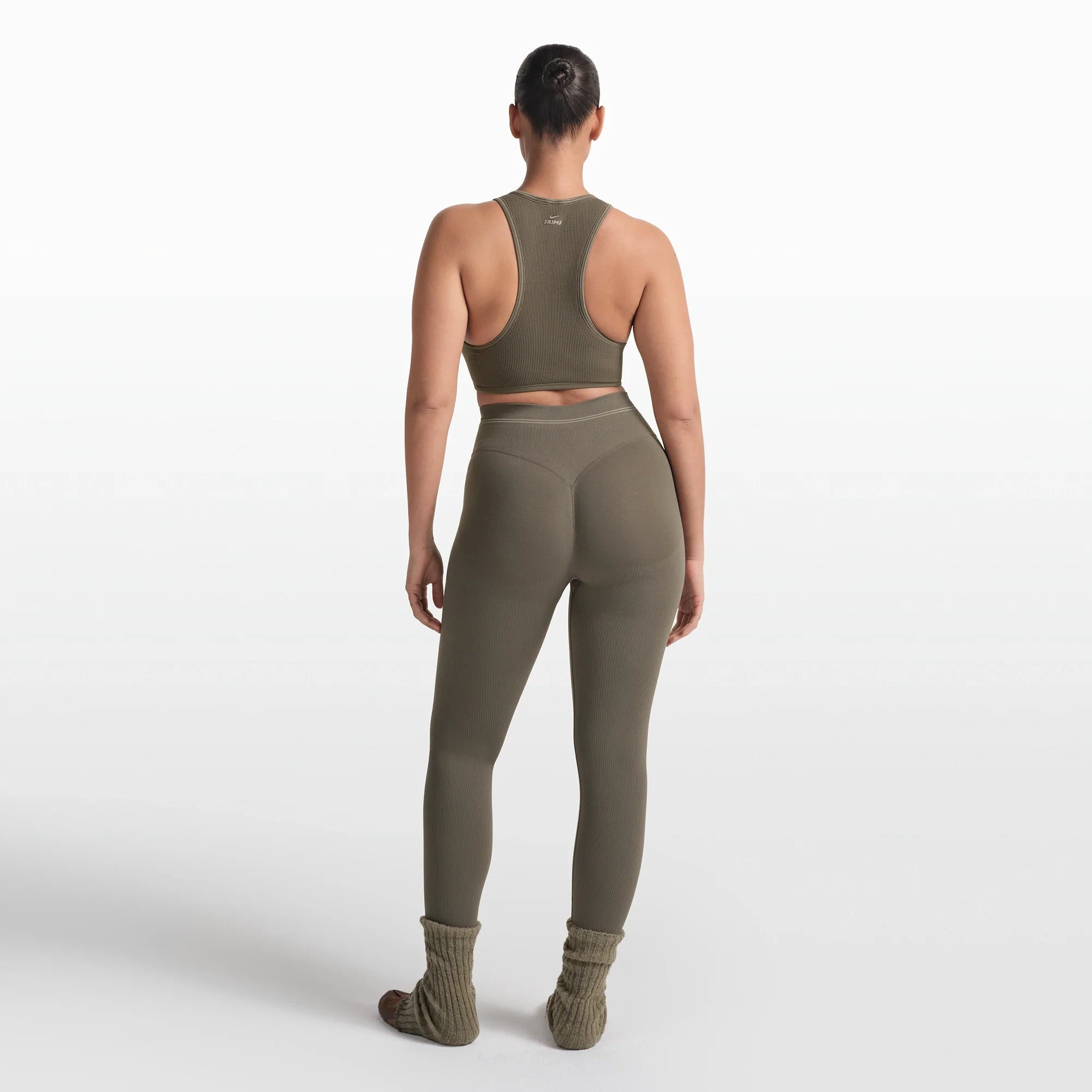 NikeSKIMS RIBBED SEAMLESS 26" LEGGING | DUSTY OAKMOSS ON A MODEL FRONT VIEW @ | FOCUS: 0.0, 1.0, 0.9
