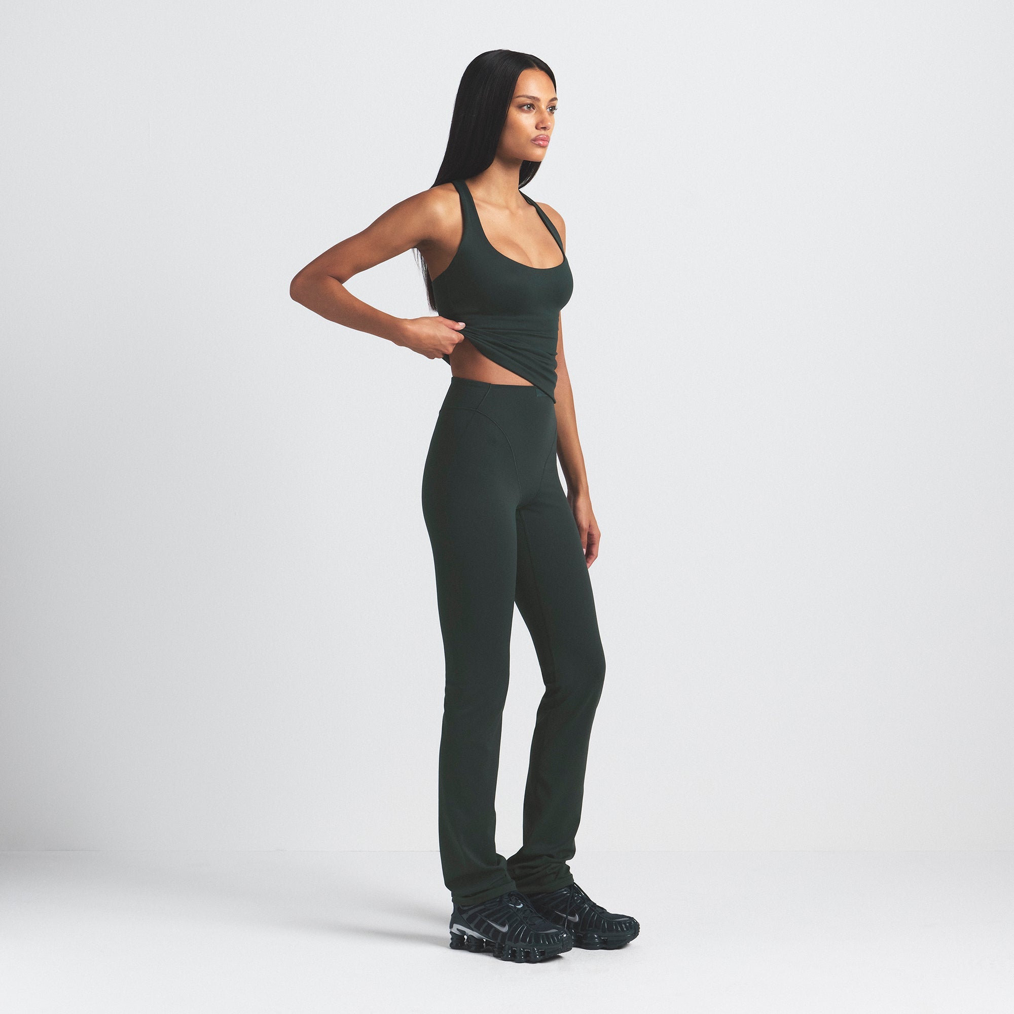 NikeSKIMS MATTE V-LINE 39" STRAIGHT LEGGING | DARK TEAL ON A MODEL SIDE VIEW @ | FOCUS: 0.0, 1.0, 0.9
