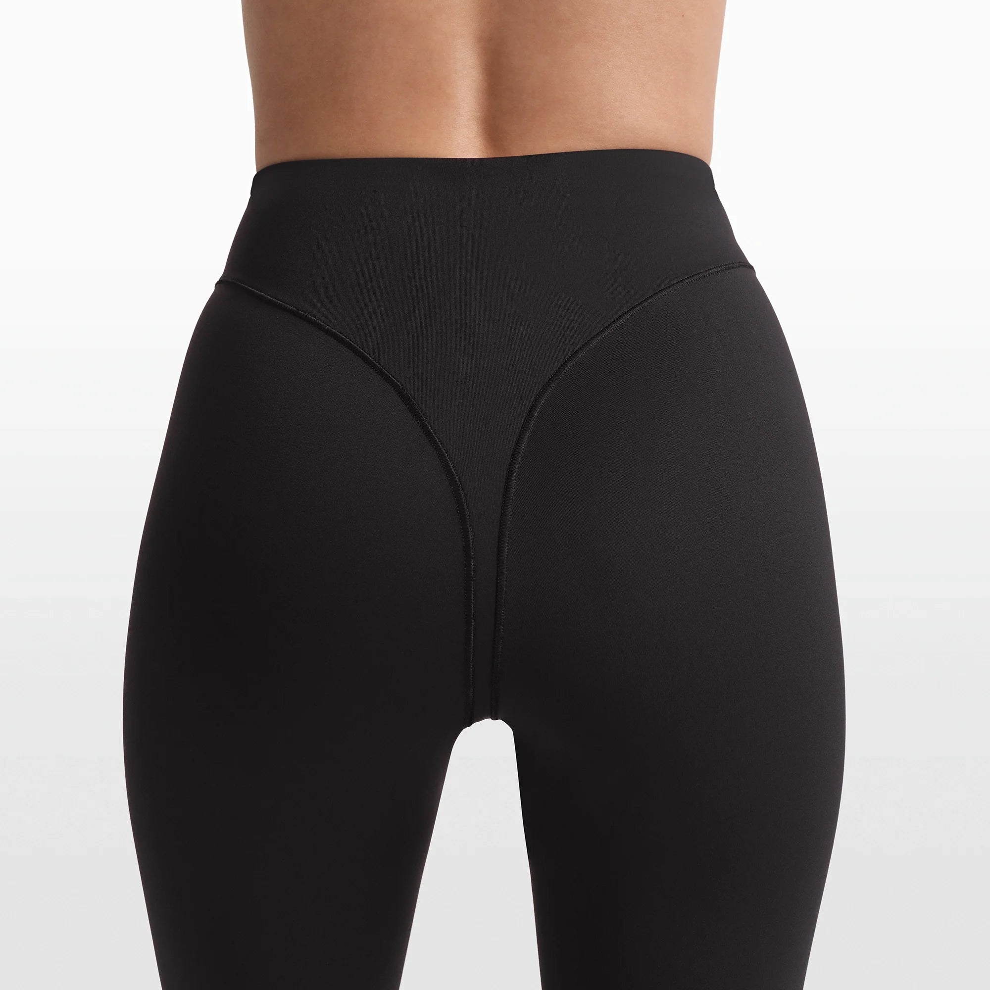 NikeSKIMS MATTE 17" V-LINE CROP LEGGING | OBSIDIAN ON A MODEL FRONT VIEW @ | FOCUS: 0.0, 1.0, 0.9