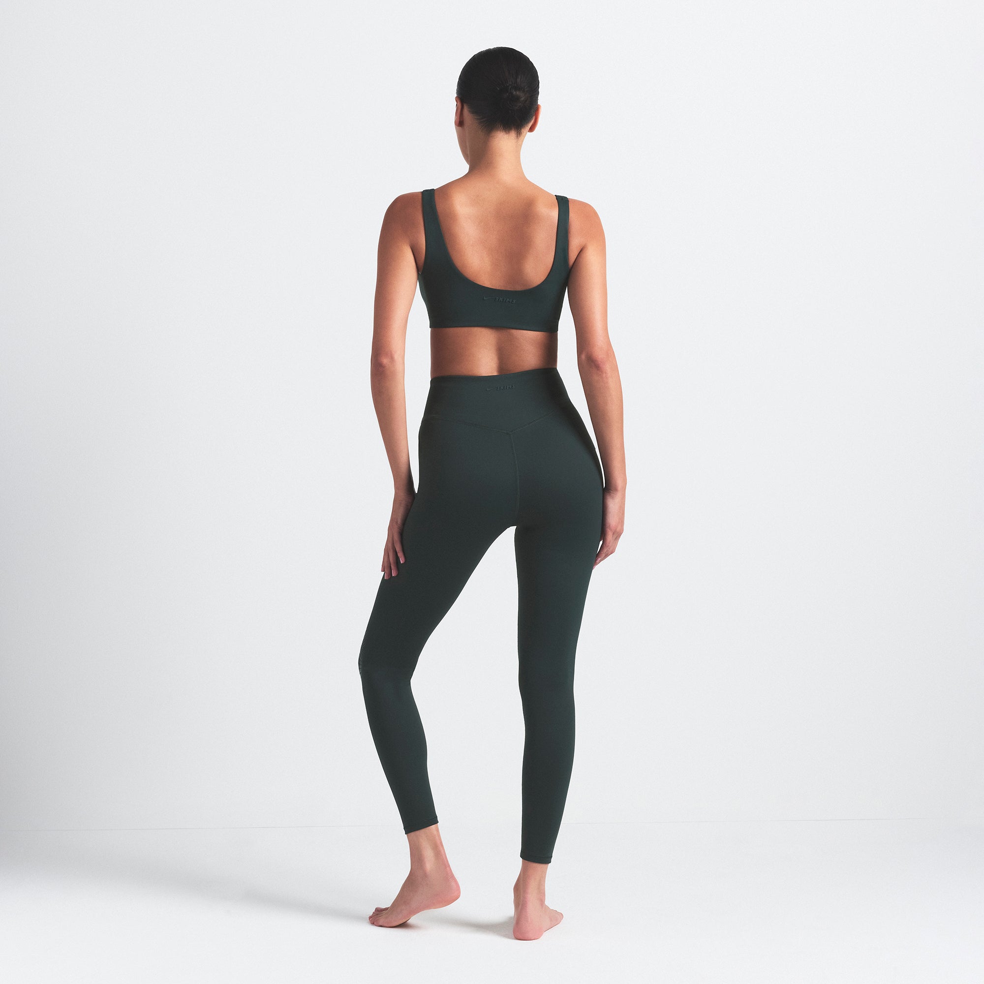NikeSKIMS MATTE KNEE GRIP 26" LEGGING | DARK TEAL ON A MODEL SIDE VIEW @ | FOCUS: 0.0, 1.0, 0.9
