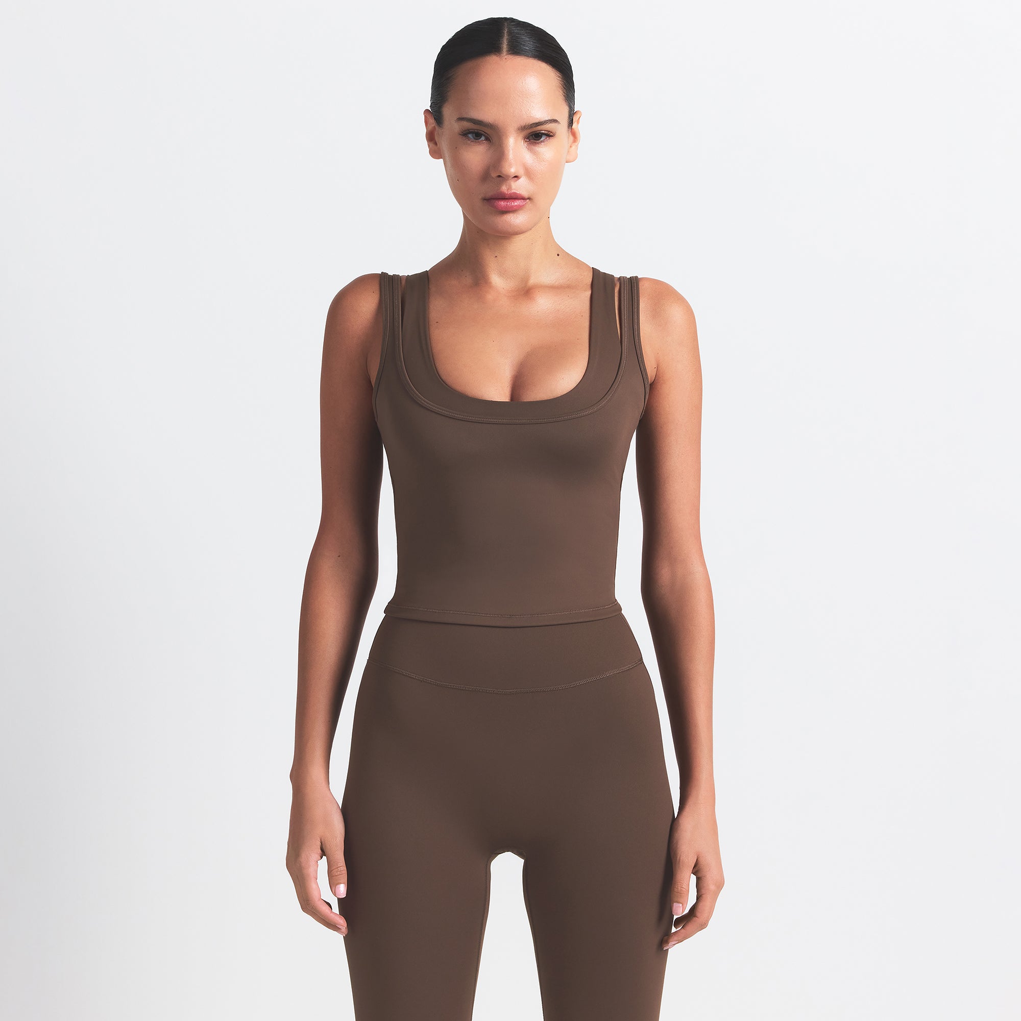 NikeSKIMS MATTE KNEE GRIP 26" LEGGING | DARK SEPIA ON A MODEL FRONT VIEW @ | FOCUS: 0.0, 1.0, 0.9