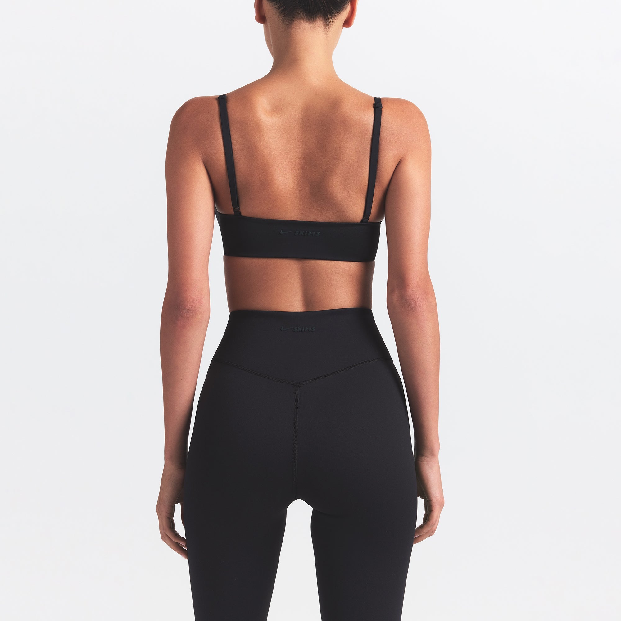 NikeSKIMS MATTE KNEE GRIP 26" LEGGING | OBSIDIAN ON A MODEL BACK VIEW @ | FOCUS: 0.0, 1.0, 0.9
