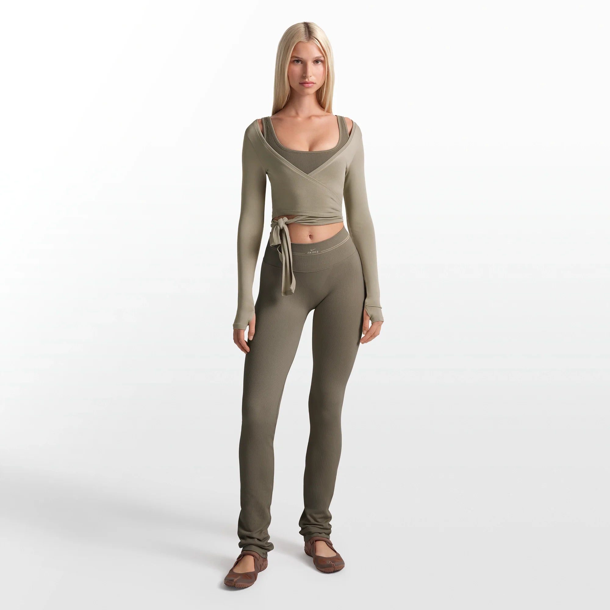 NikeSKIMS RIBBED SEAMLESS 34" STRAIGHT LEGGING | DUSTY OAKMOSS ON A MODEL FRONT VIEW @ | FOCUS: 0.0, 1.0, 0.9