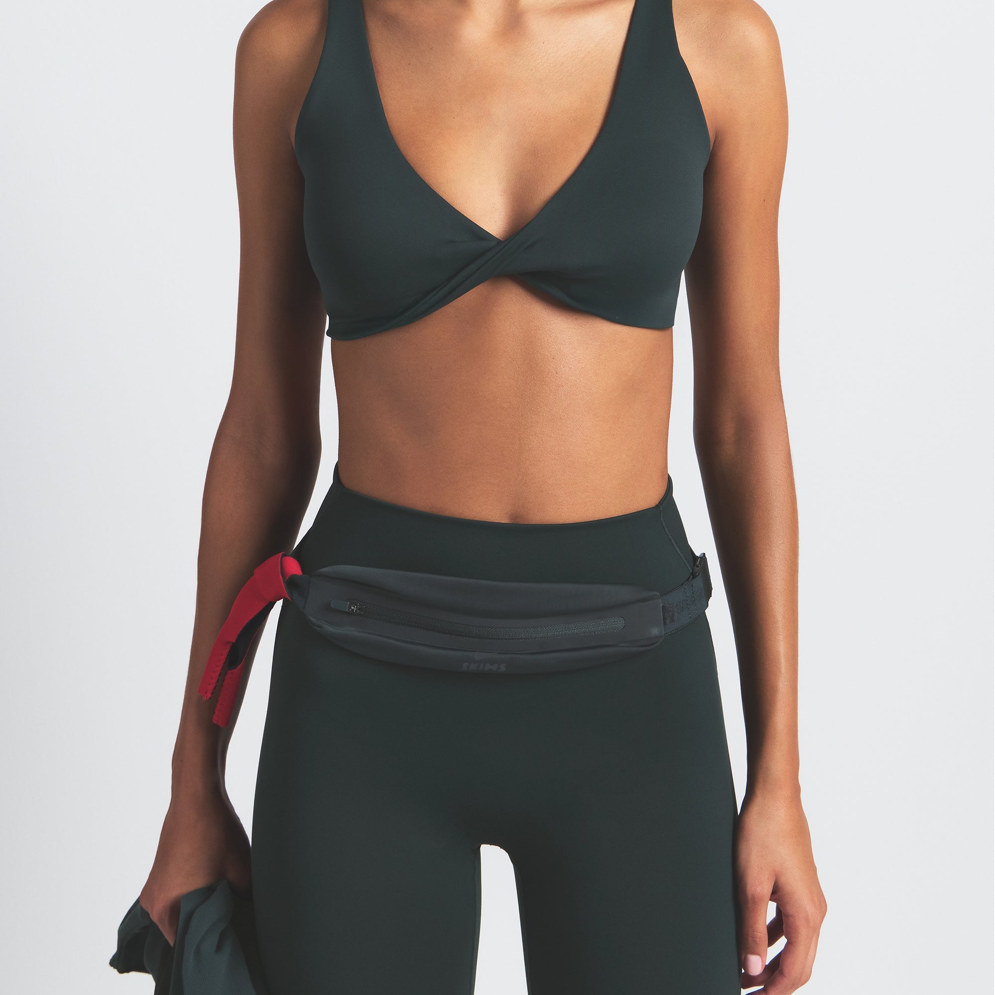 NikeSKIMS SLIM WAISTPACK | DARK TEAL ON A MODEL FRONT VIEW @ | FOCUS: 0.0, 1.0, 0.9