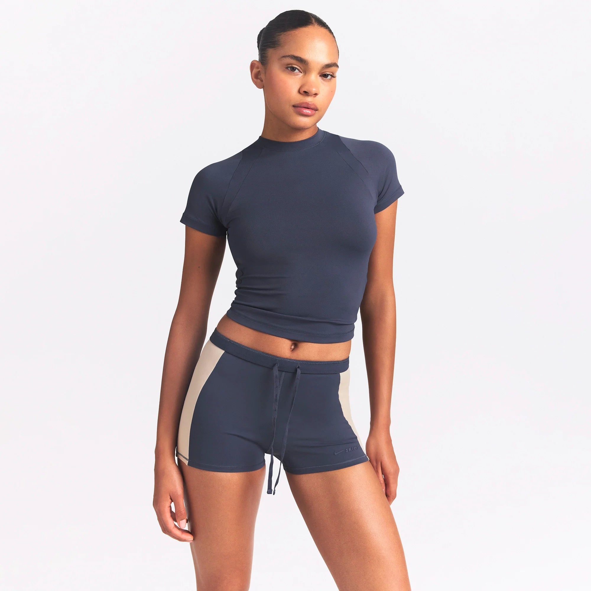 NikeSKIMS MATTE AND SHINE DRAWCORD 2" SHORT | DEEP ROYAL/STONE ON A MODEL SIDE VIEW @ | FOCUS: 0.0, 1.0, 0.9