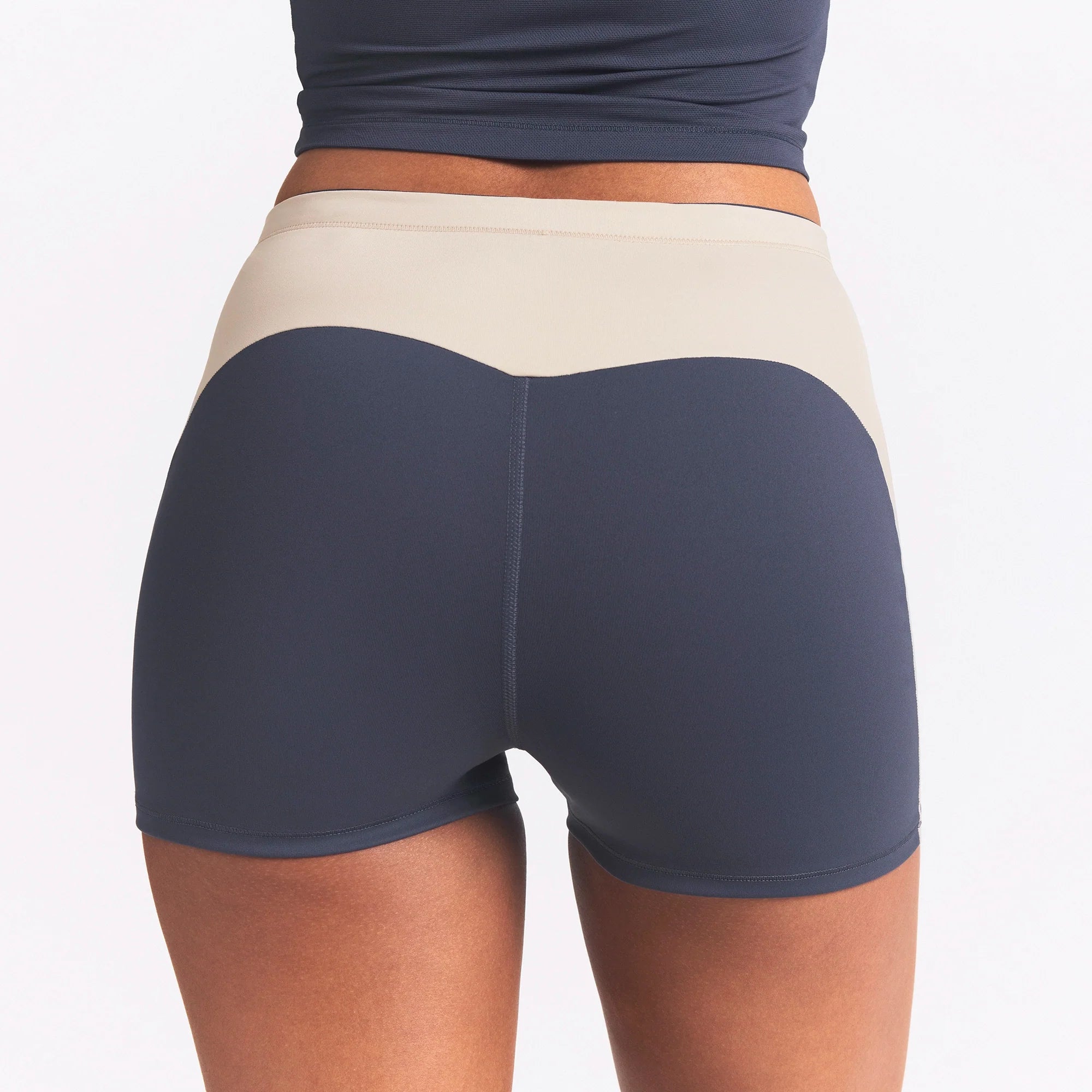 NikeSKIMS MATTE AND SHINE DRAWCORD 2" SHORT | DEEP ROYAL/STONE ON A MODEL SIDE VIEW @ | FOCUS: 0.0, 1.0, 0.9