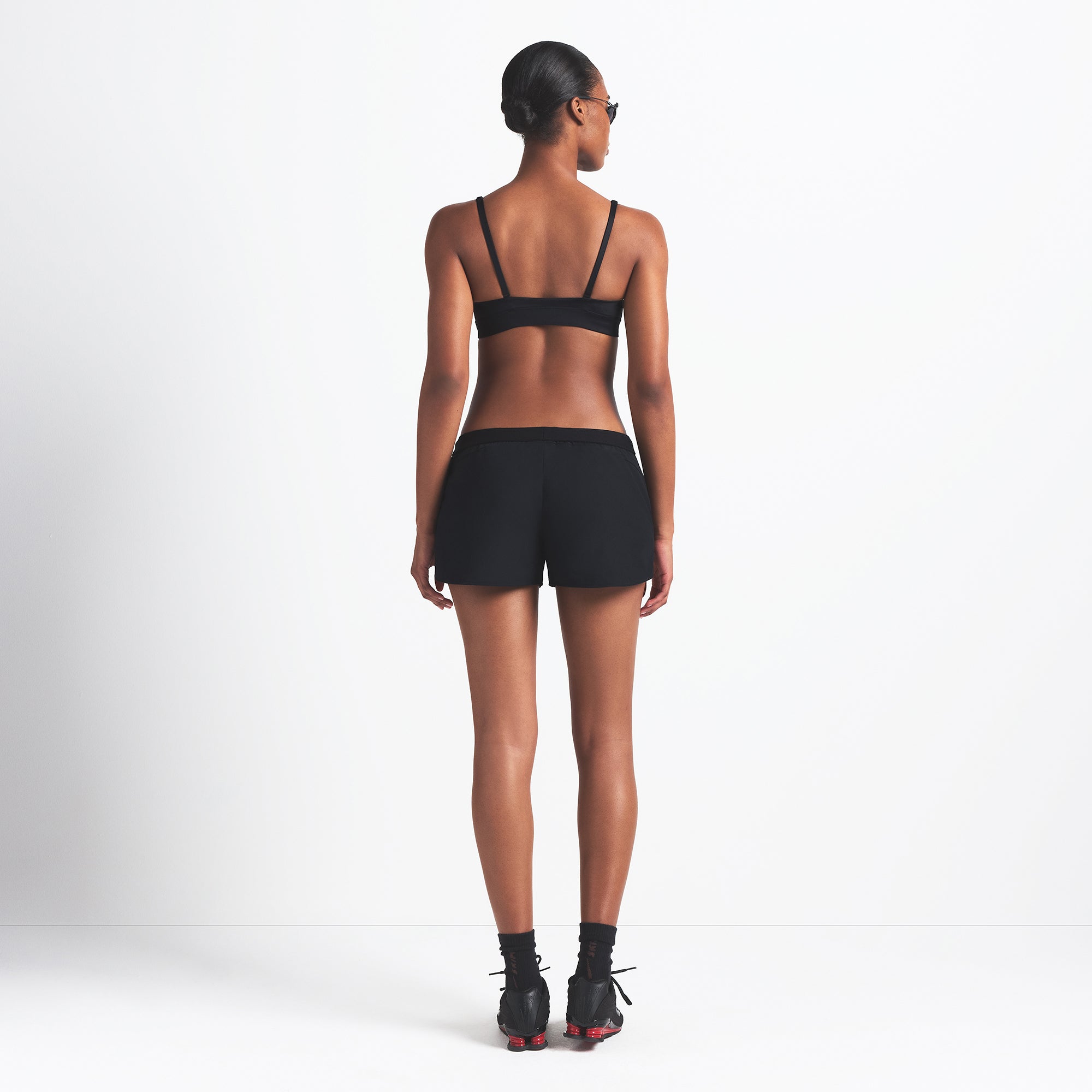 NikeSKIMS WOVEN NYLON 2.5" RUNNER SHORT | OBSIDIAN ON A MODEL BACK VIEW @ | FOCUS: 0.0, 1.0, 0.9