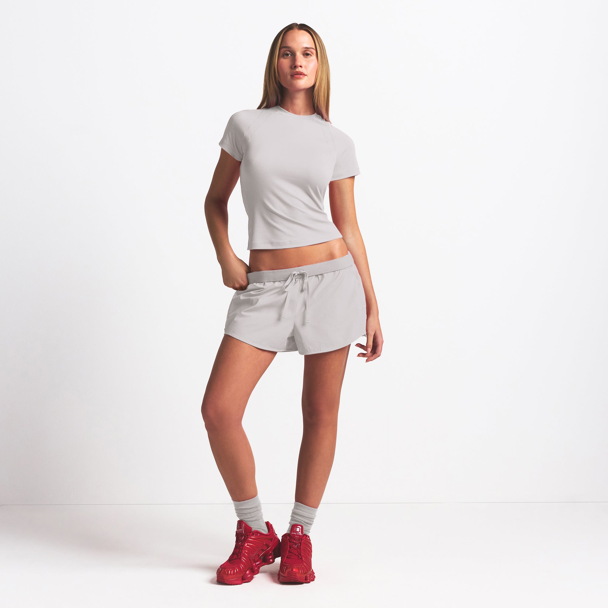 NikeSKIMS WOVEN NYLON 2.5" RUNNER SHORT | STONE ON A MODEL FRONT VIEW @ | FOCUS: 0.9, 0.1, 0.7