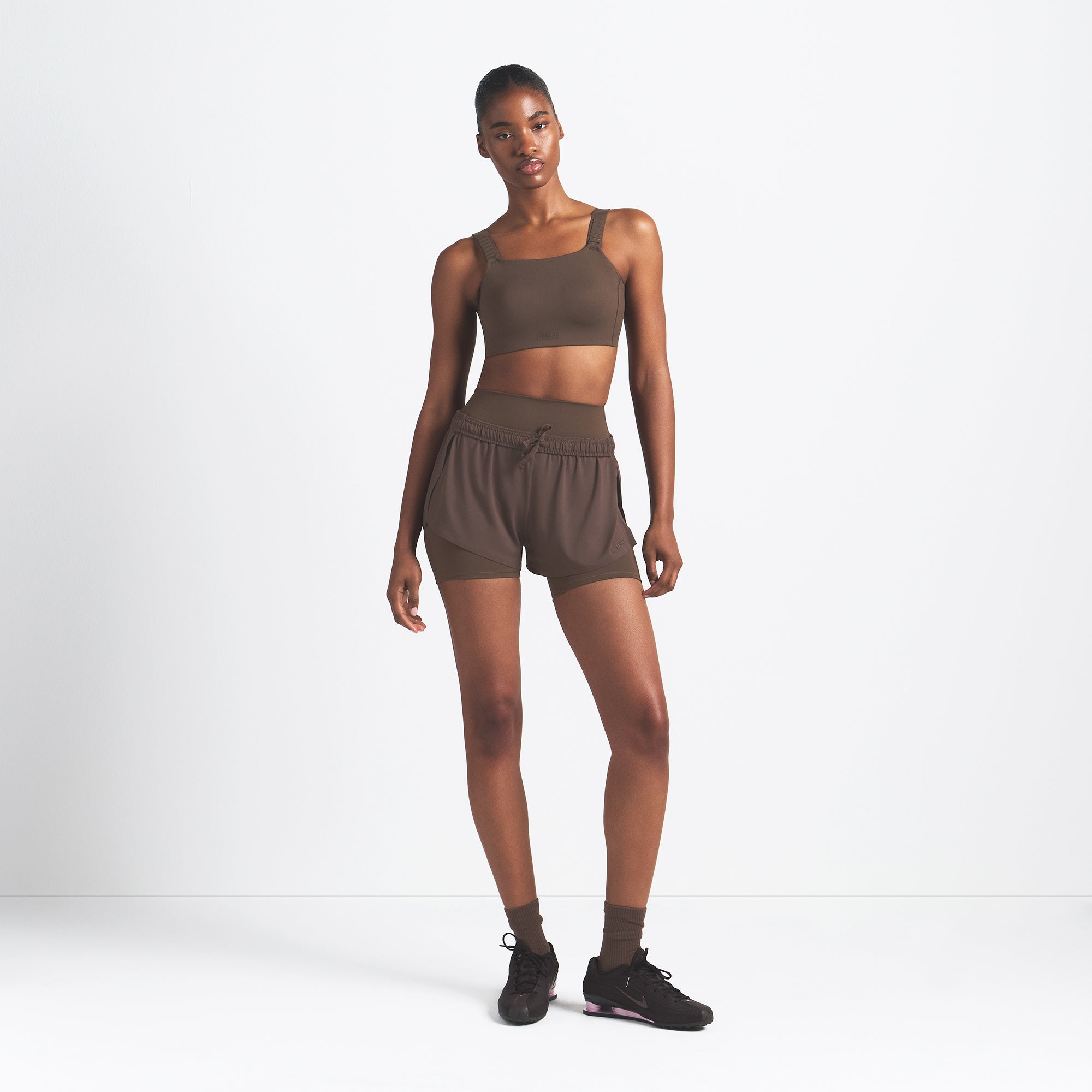 NikeSKIMS AIRY MINI SHORT | DARK SEPIA ON A MODEL FRONT VIEW @ | FOCUS: 0.9, 0.1, 0.7
