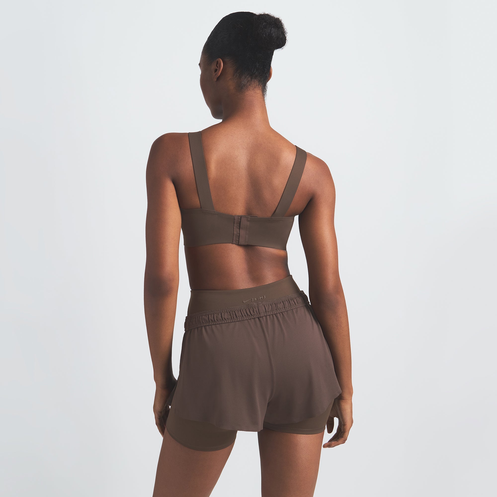 NikeSKIMS AIRY MINI SHORT | DARK SEPIA ON A MODEL BACK VIEW @ | FOCUS: 0.9, 0.1, 0.7