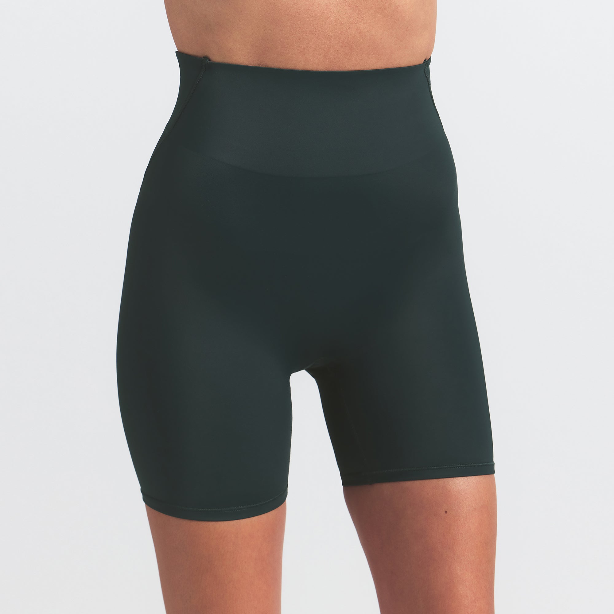 NikeSKIMS SHINE BONDED WAIST 5" BIKER SHORT | DARK TEAL ON A MODEL SIDE VIEW @ | FOCUS: 0.0, 1.0, 0.9