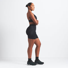 NikeSKIMS SHINE BONDED WAIST 5" BIKER SHORT | OBSIDIAN ON A MODEL FRONT VIEW