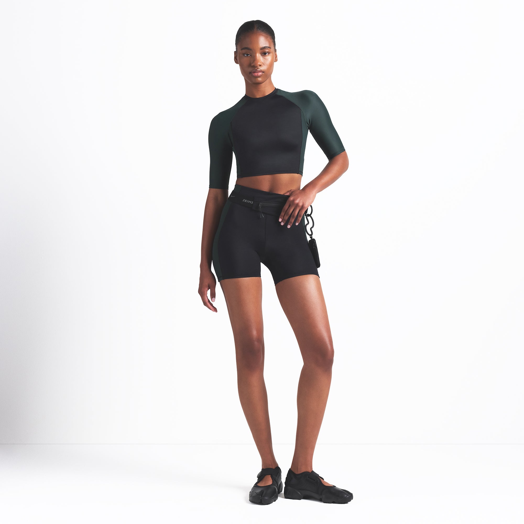NikeSKIMS SHINE 5" BIKER SHORT | OBSIDIAN AND DARK TEAL ON A MODEL FRONT VIEW @ | FOCUS: 0.0, 1.0, 0.9