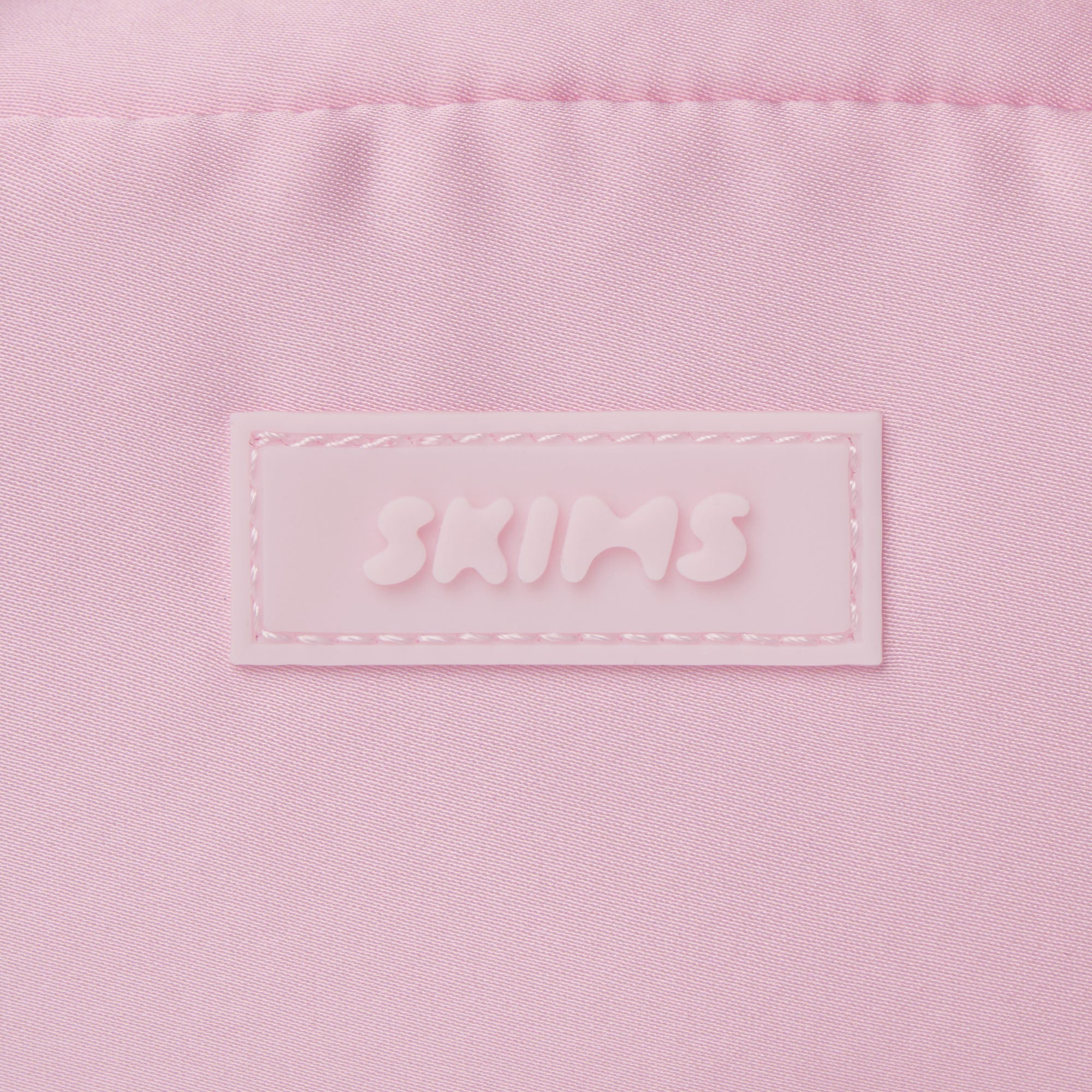 SKIMS ACCESSORIES SATIN MINI DUFFLE BAG | PEONY ADDITIONAL FABRIC DETAILS